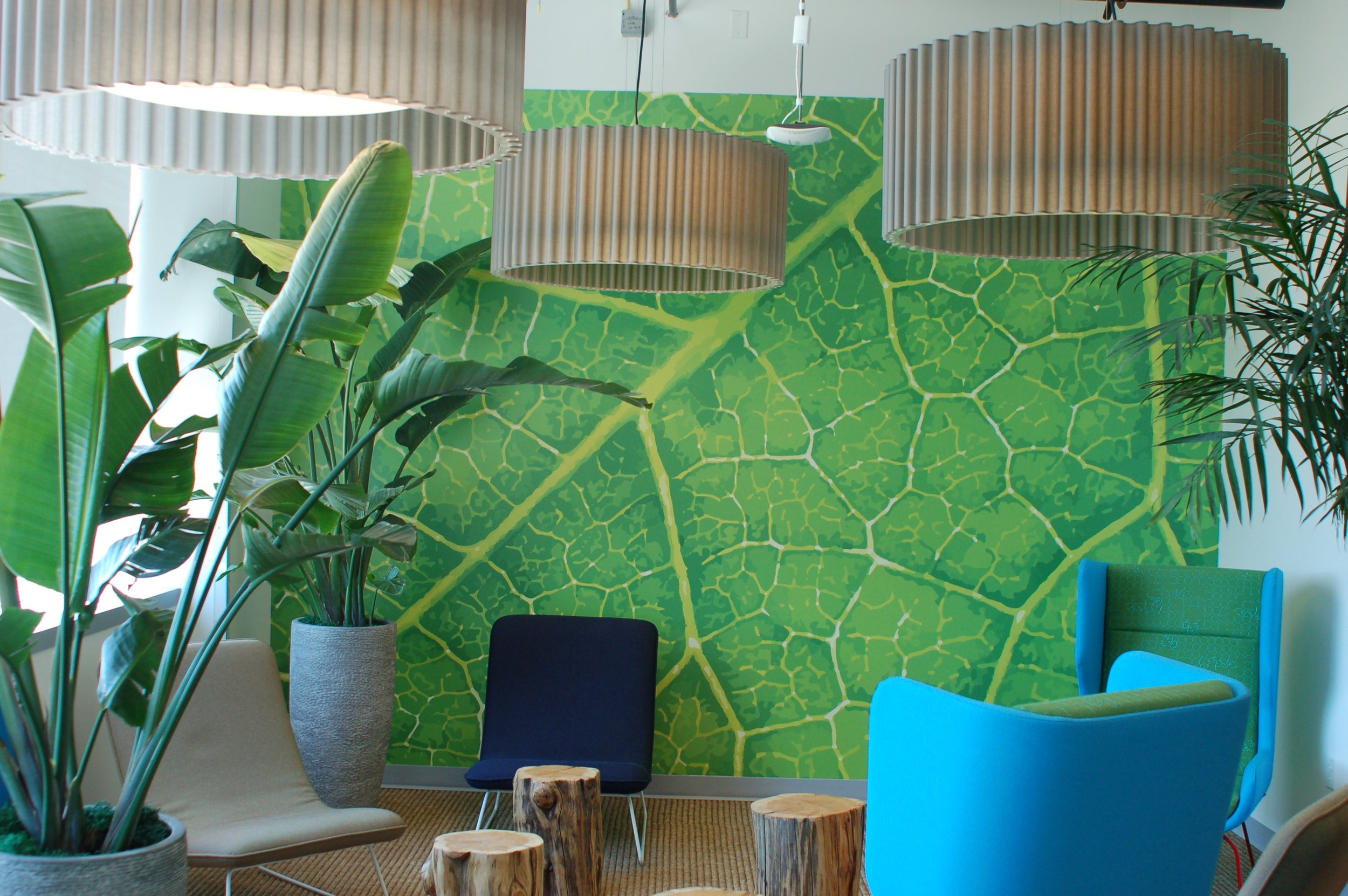 Custom patterned environmental wall graphic adding color and texture to a collaborative office space.