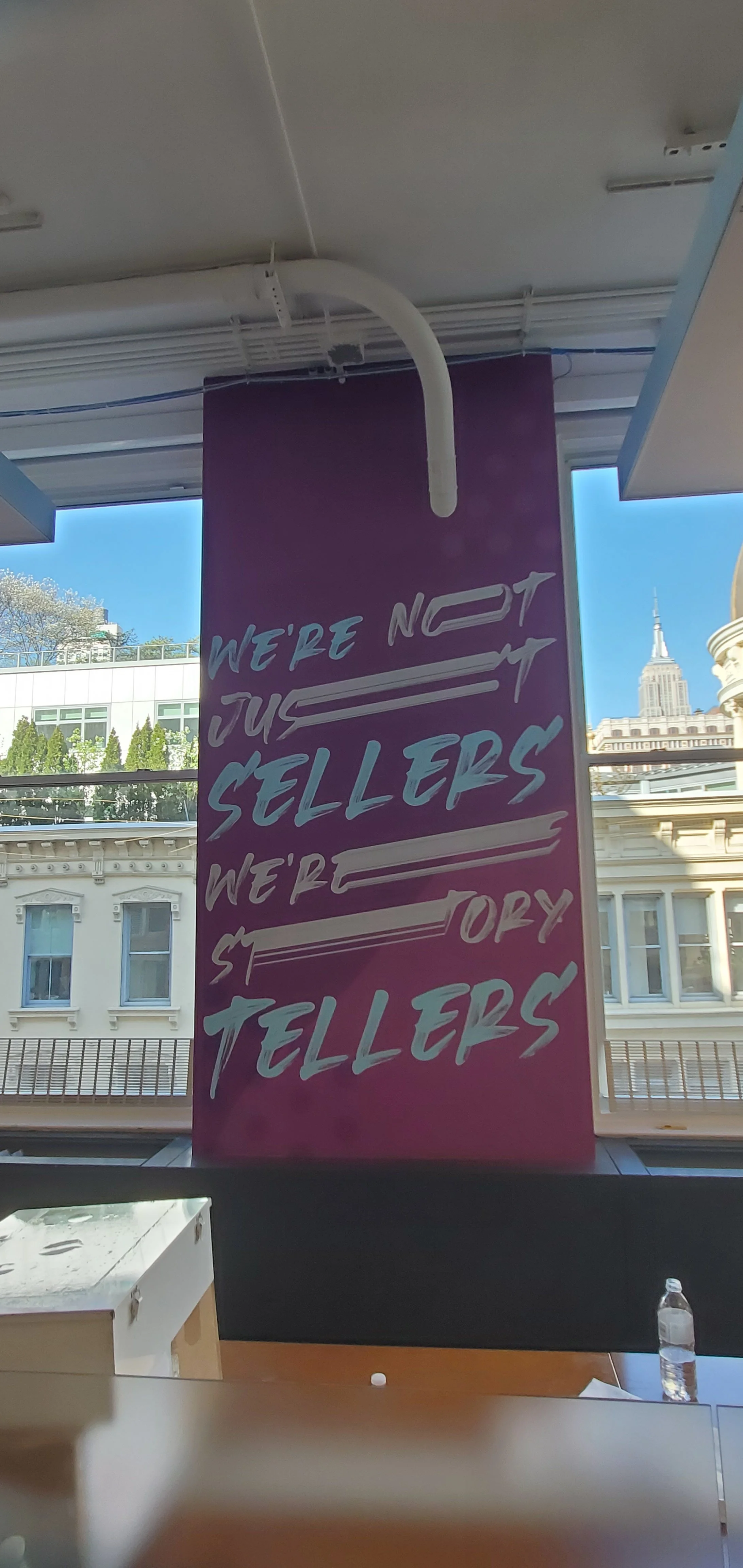Front view of installed vertical branded wall graphic at eBay New York office featuring workplace messaging as part of environmental graphics program