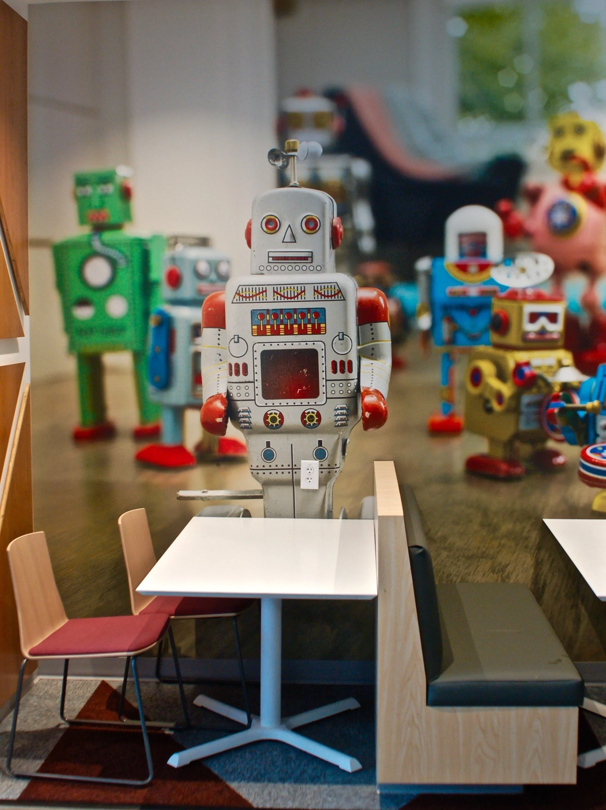 Custom environmental graphics featuring large-scale character artwork used to create a themed workspace experience.