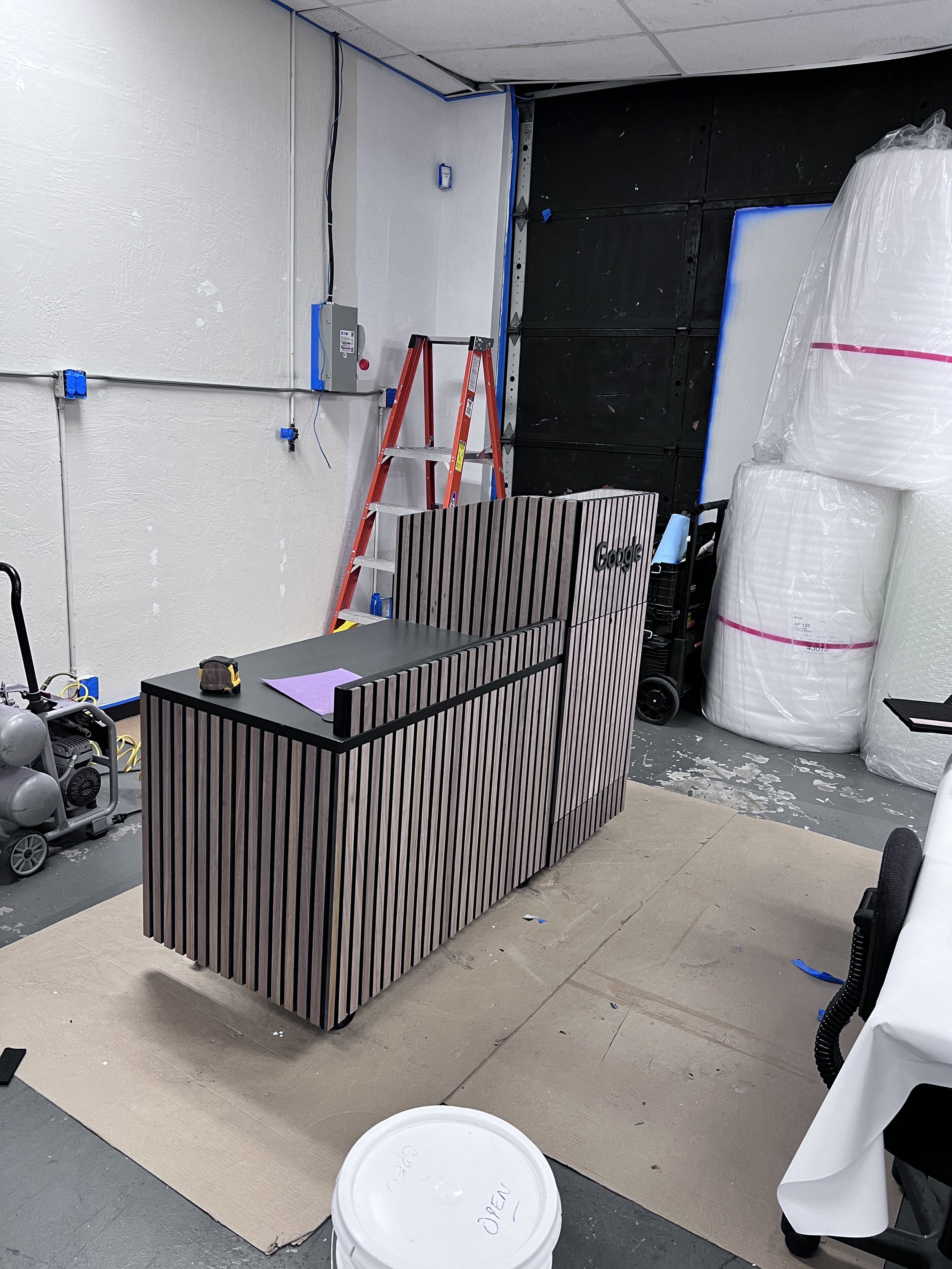 Custom curved architectural feature fabricated with layered dimensional elements to create a sculptural branded environment.