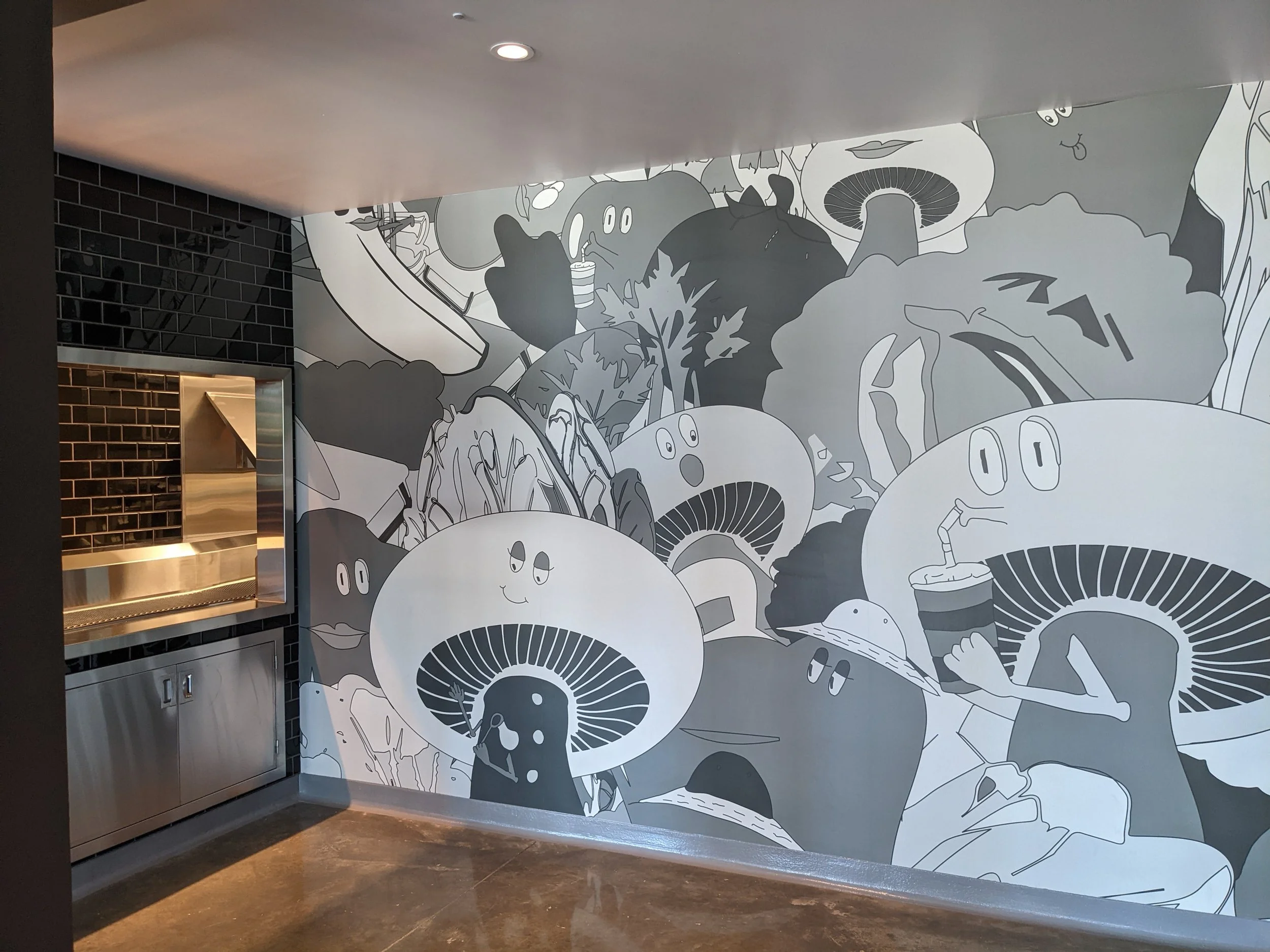 Installed custom illustrated wallcovering mural in a commercial restaurant space featuring large-format environmental graphics and interior branding