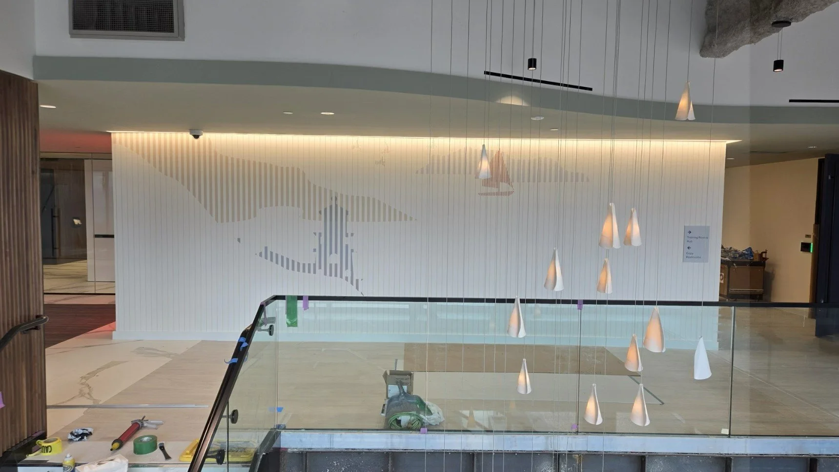 Installed textured wallcovering forming a subtle graphic feature wall in the KPMG office lobby in Minneapolis, Minnesota.