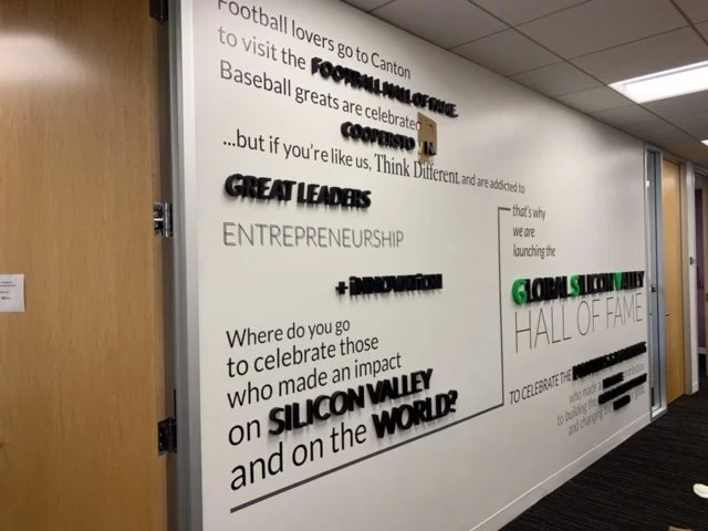 Custom environmental wall graphics installed to showcase company messaging and enhance workplace branding in corporate office