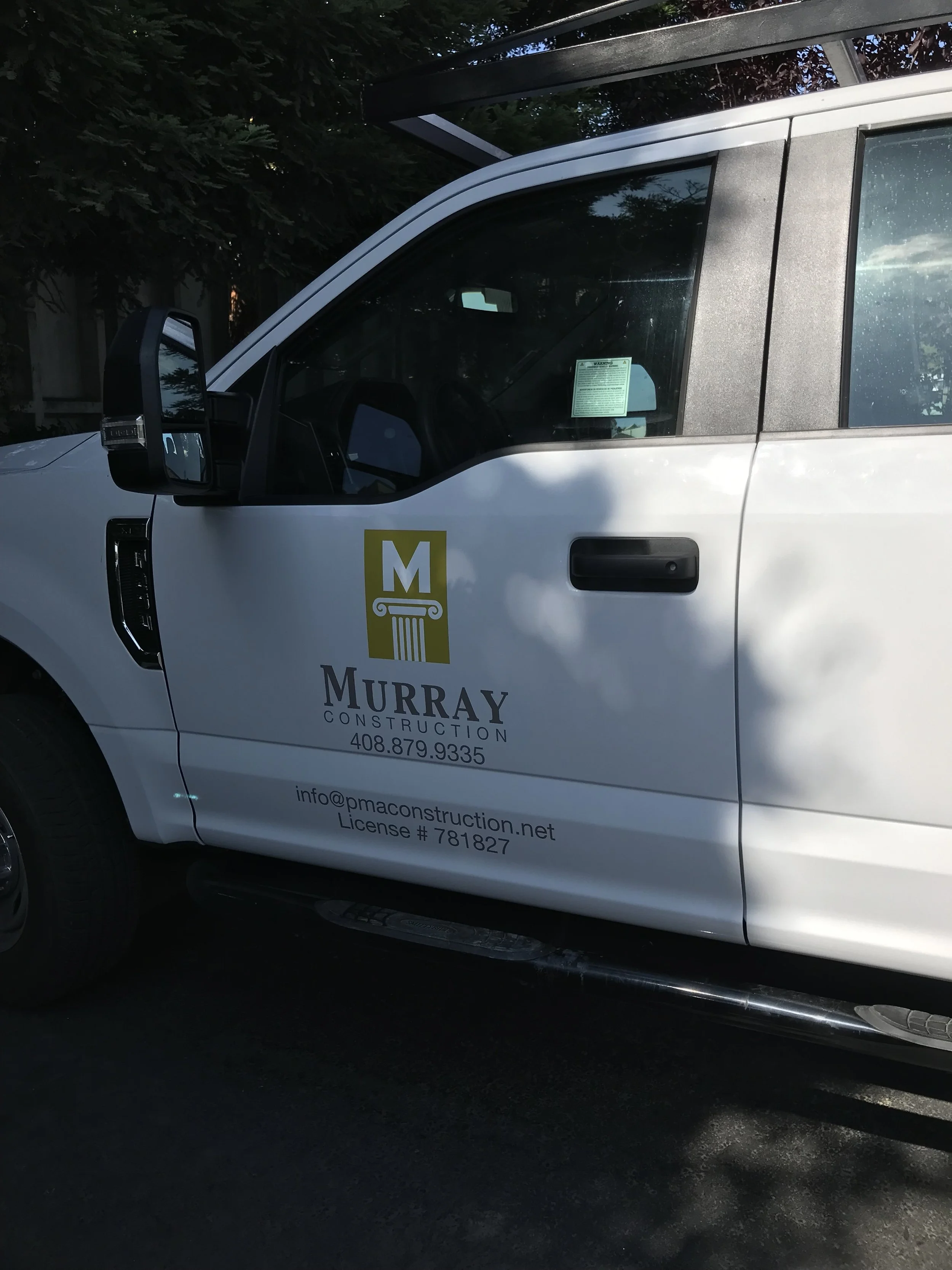 Branded service van featuring professional business lettering and door graphics for mobile company identification.
