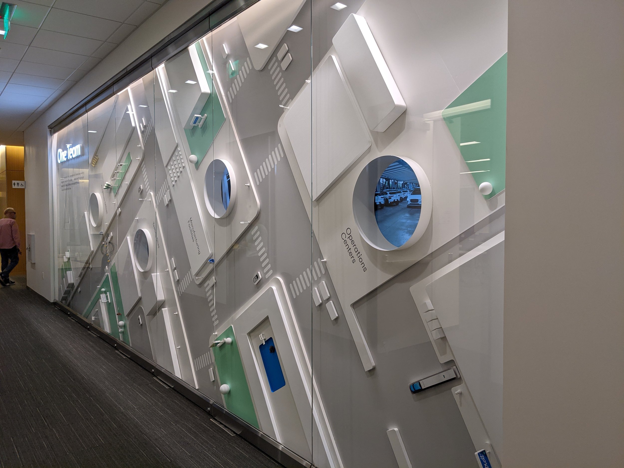 Custom environmental installation combining graphics, dimensional components, and lighting to create a cohesive branded experience.