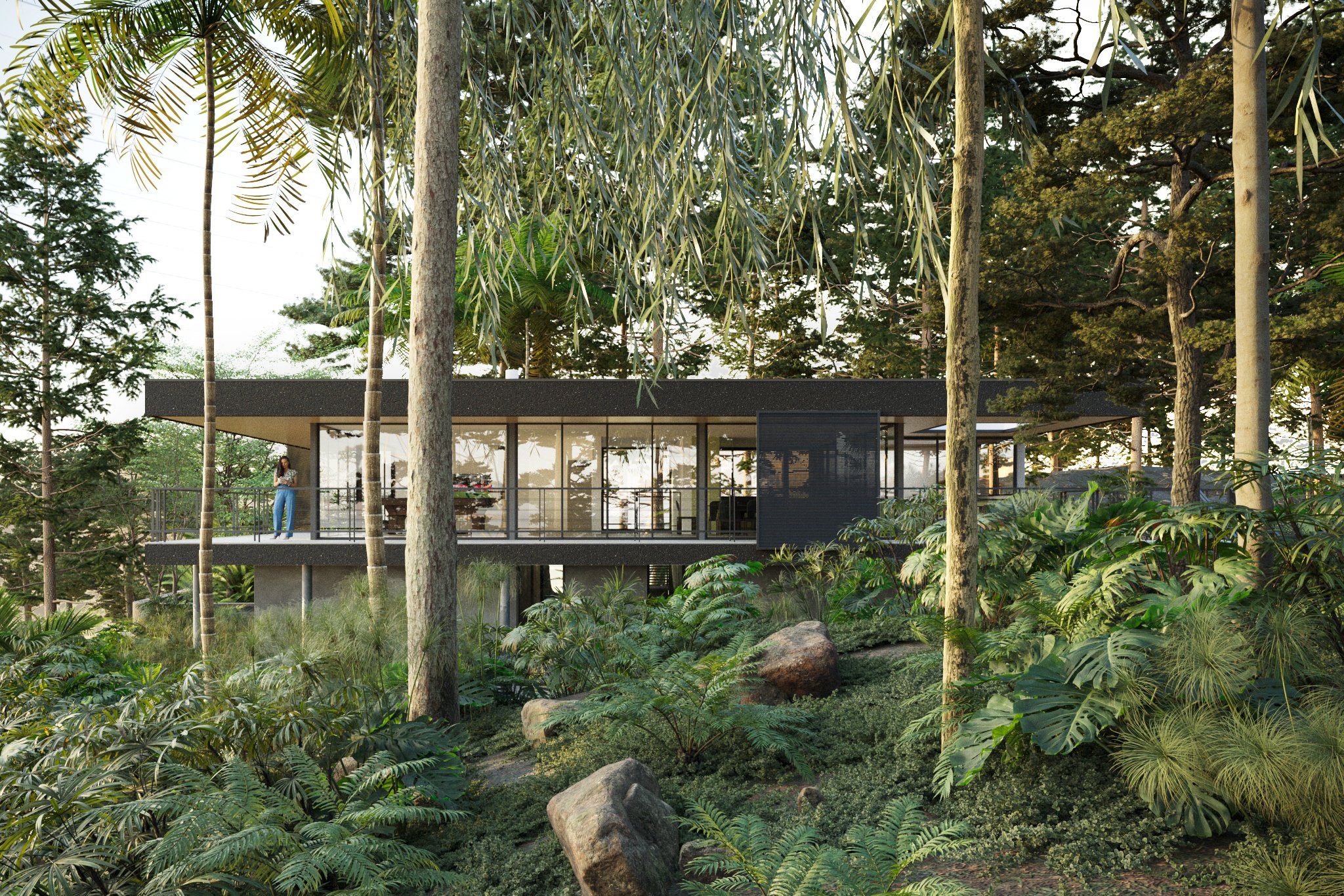 Modern house with large glass windows and black exterior, elevated among lush greenery with trees and large rocks in a forest setting.
