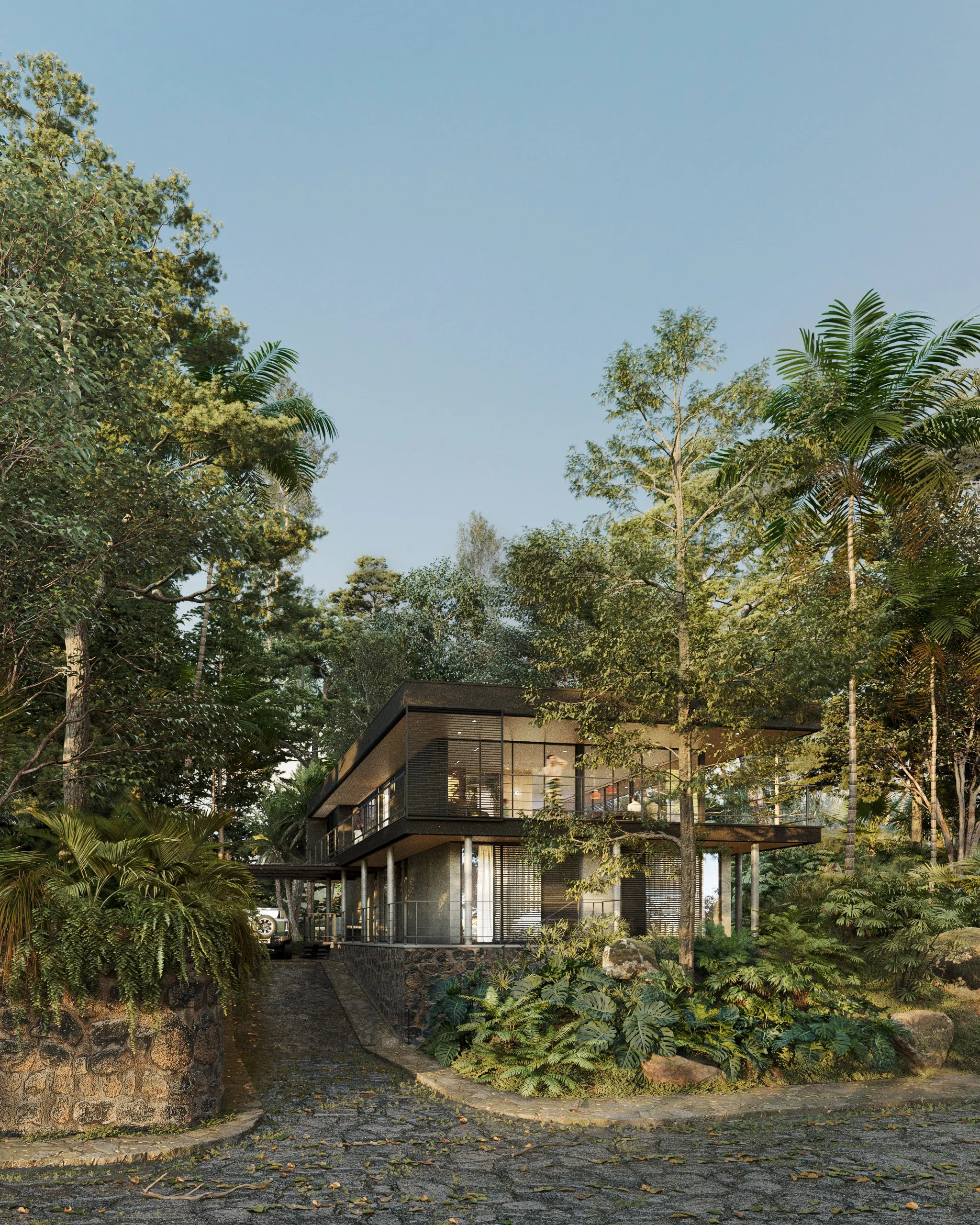 Modern house surrounded by lush trees and plants, with a cobblestone driveway leading up to it, under a clear sky.