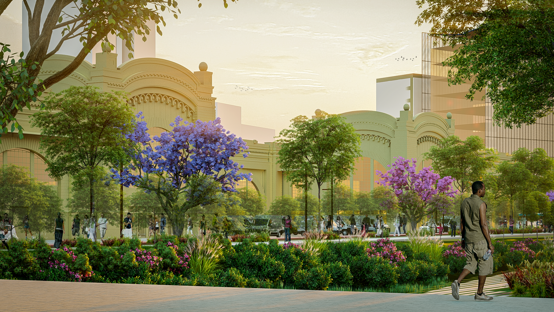 A modern urban park with colorful flowering trees and lush greenery, with people walking and socializing, surrounded by tall city buildings at sunset.