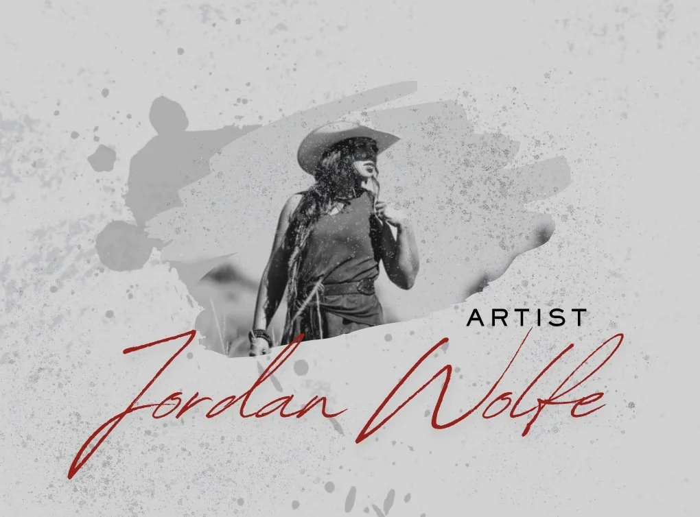 A black and white artistic portrait of a woman wearing a wide-brimmed hat, with paint splashes and abstract strokes in the background, featuring the text "Artist Jordan Wolfe."
