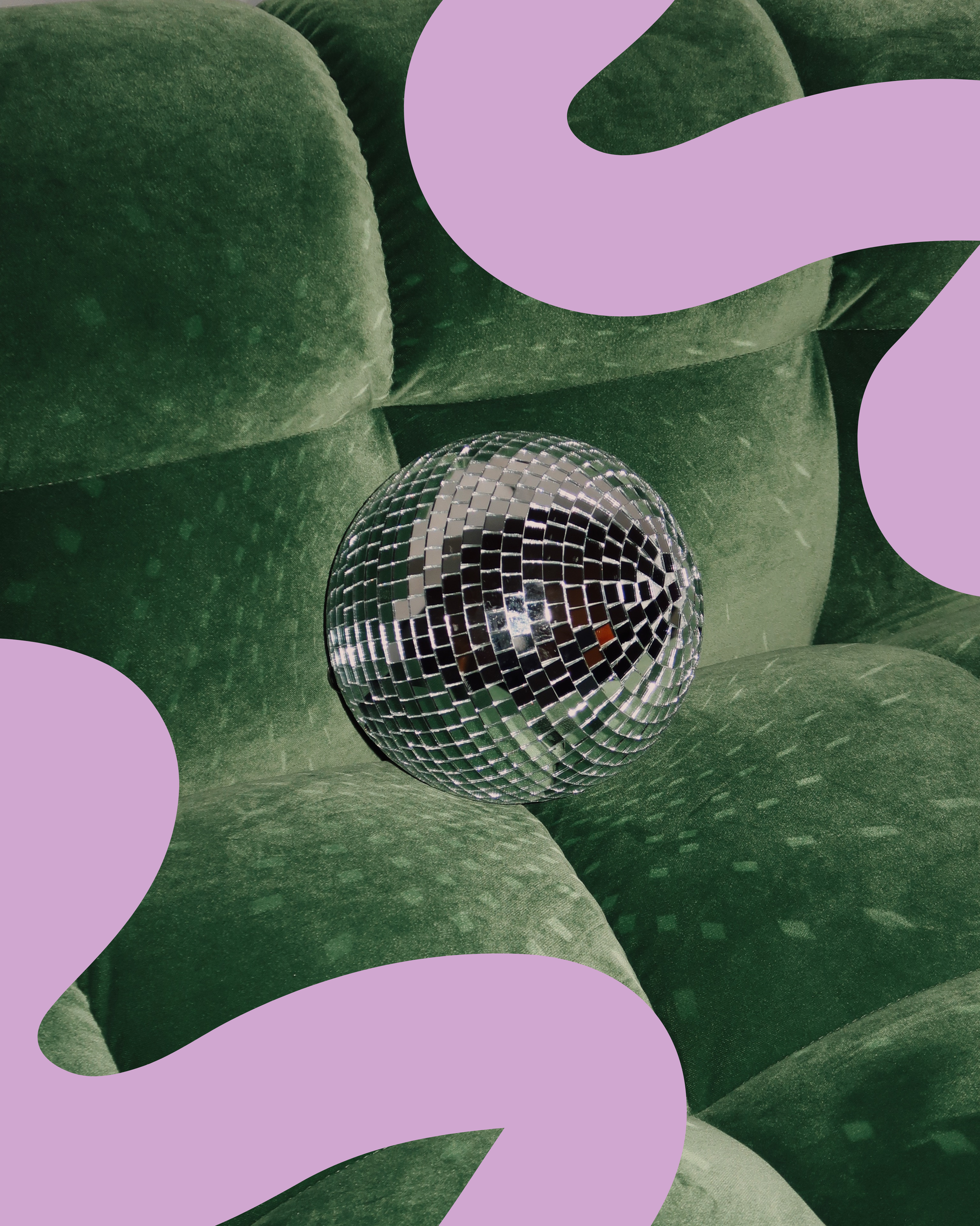 Disco ball placed on a green sofa, playful and creative studio styling