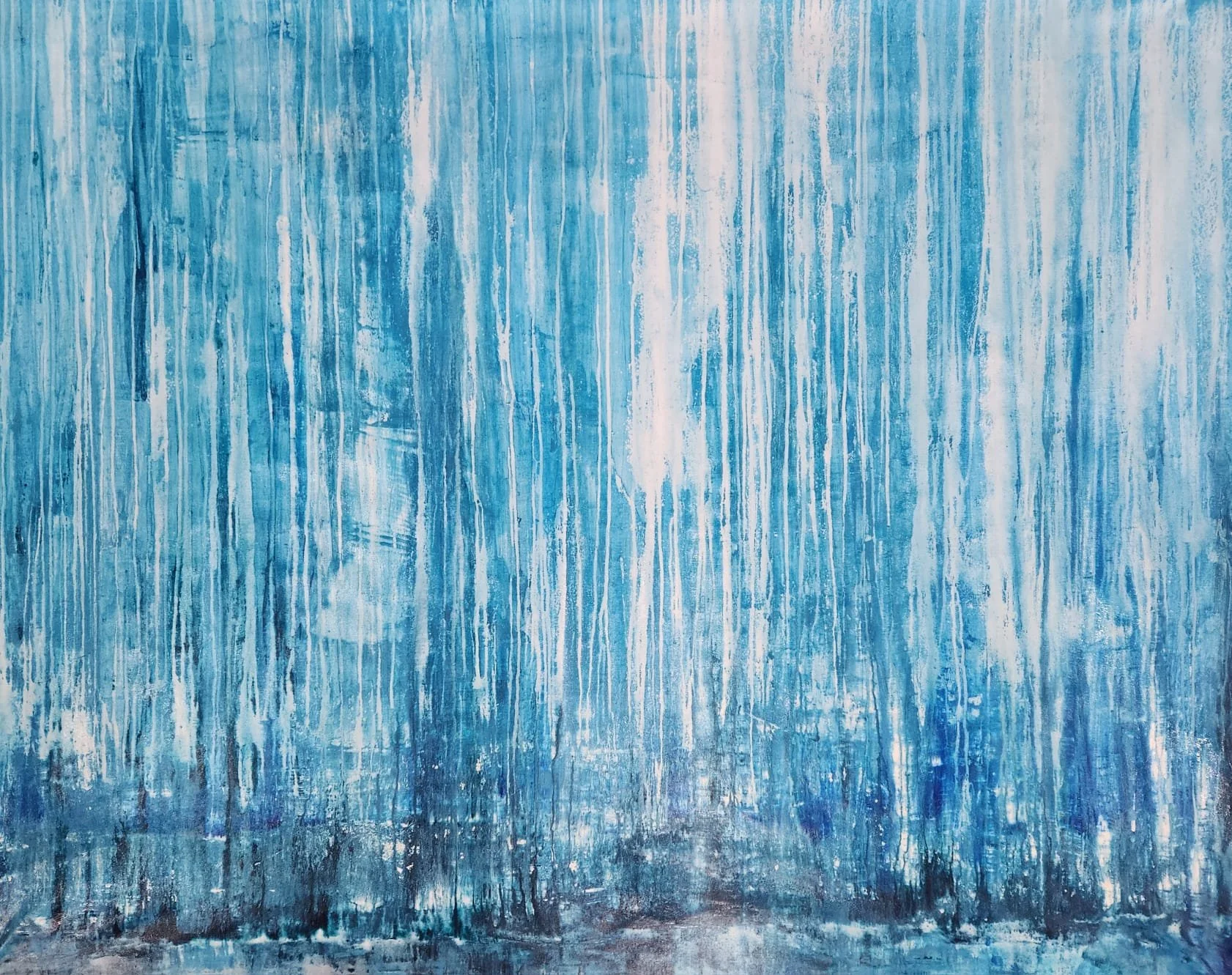 A textured wall with vertical streaks of blue, white, and black paint.