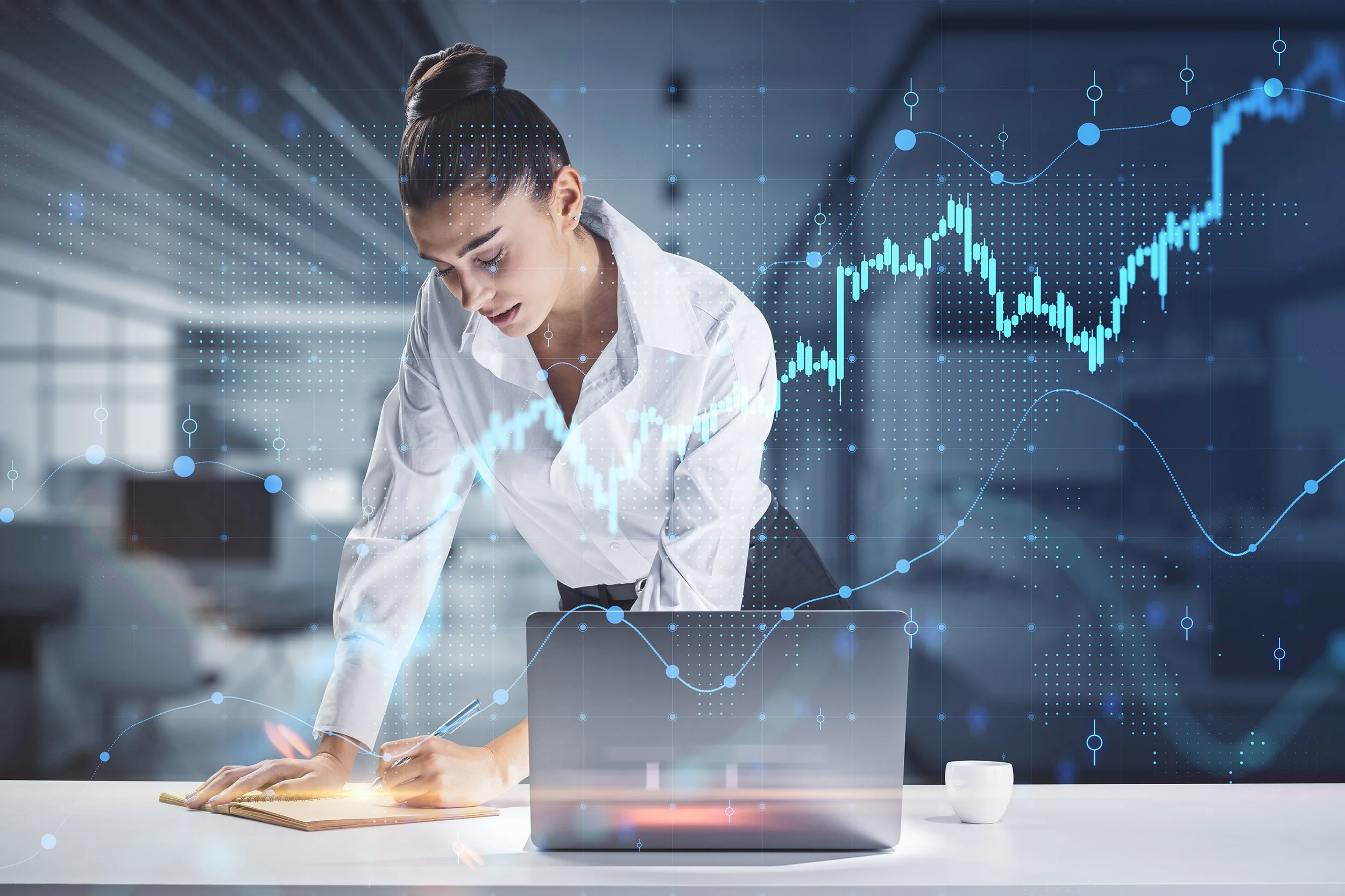 Woman in office with laptop and overlay of charts and graphs showing financial and market forecasts.