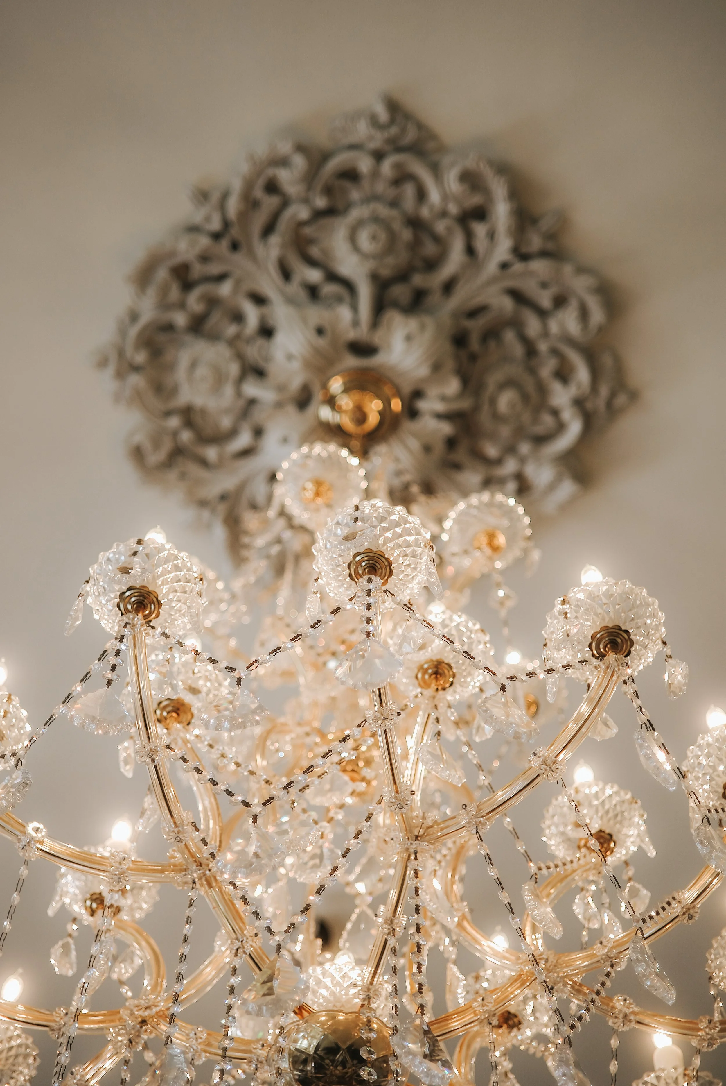 Close-up of a crystal chandelier with ornate design and hanging crystal ornaments.