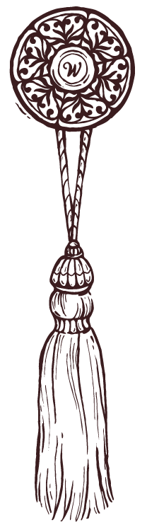 A decorative hand fan with intricate patterns and a tassel hanging from it.