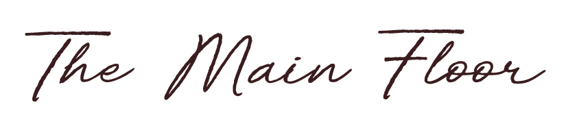 Text that reads "The Main Floor" in a stylish, dark cursive font.
