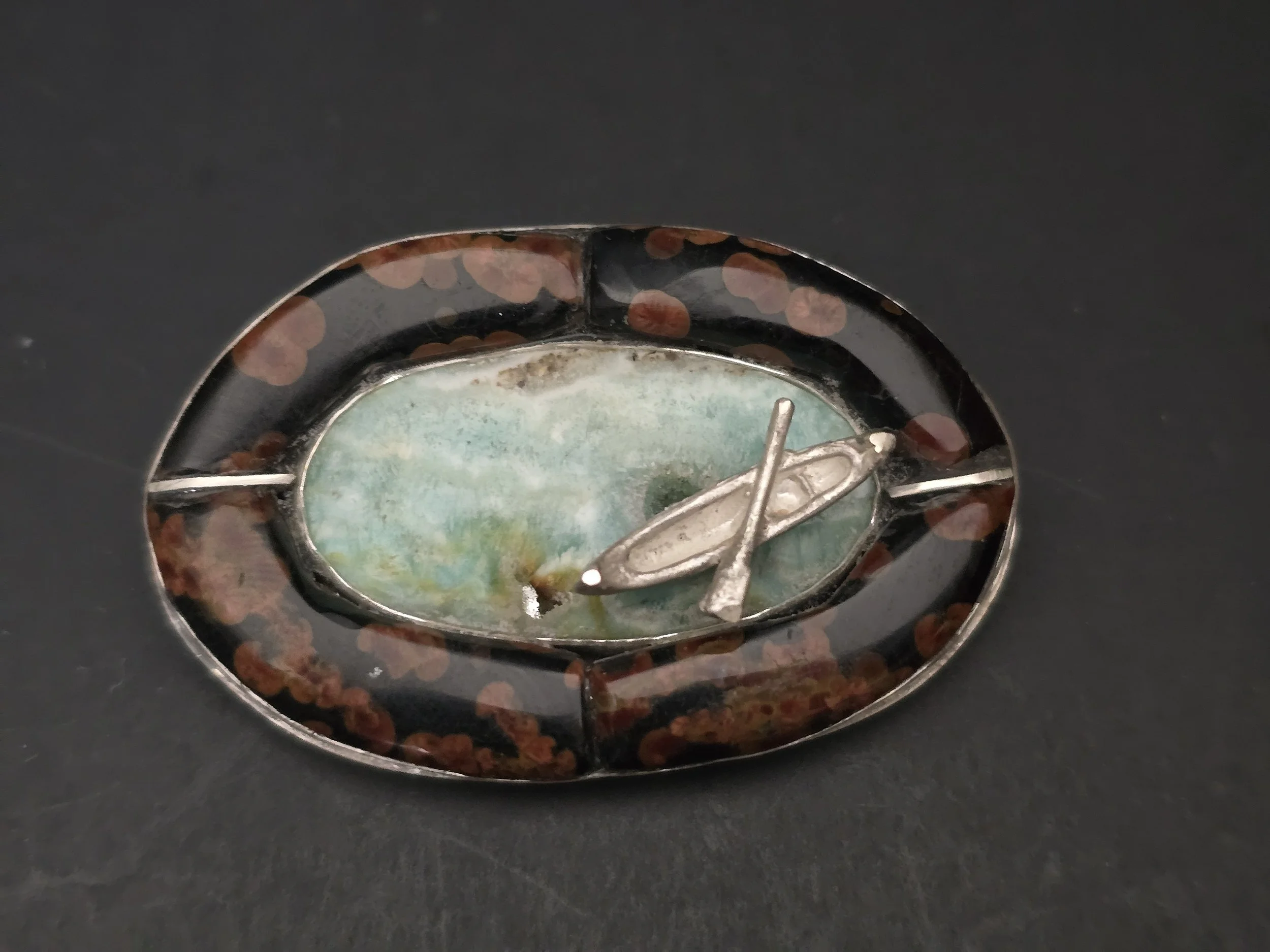 A cobblestone inlay in silver pendant Kayaking in the Salish sea.