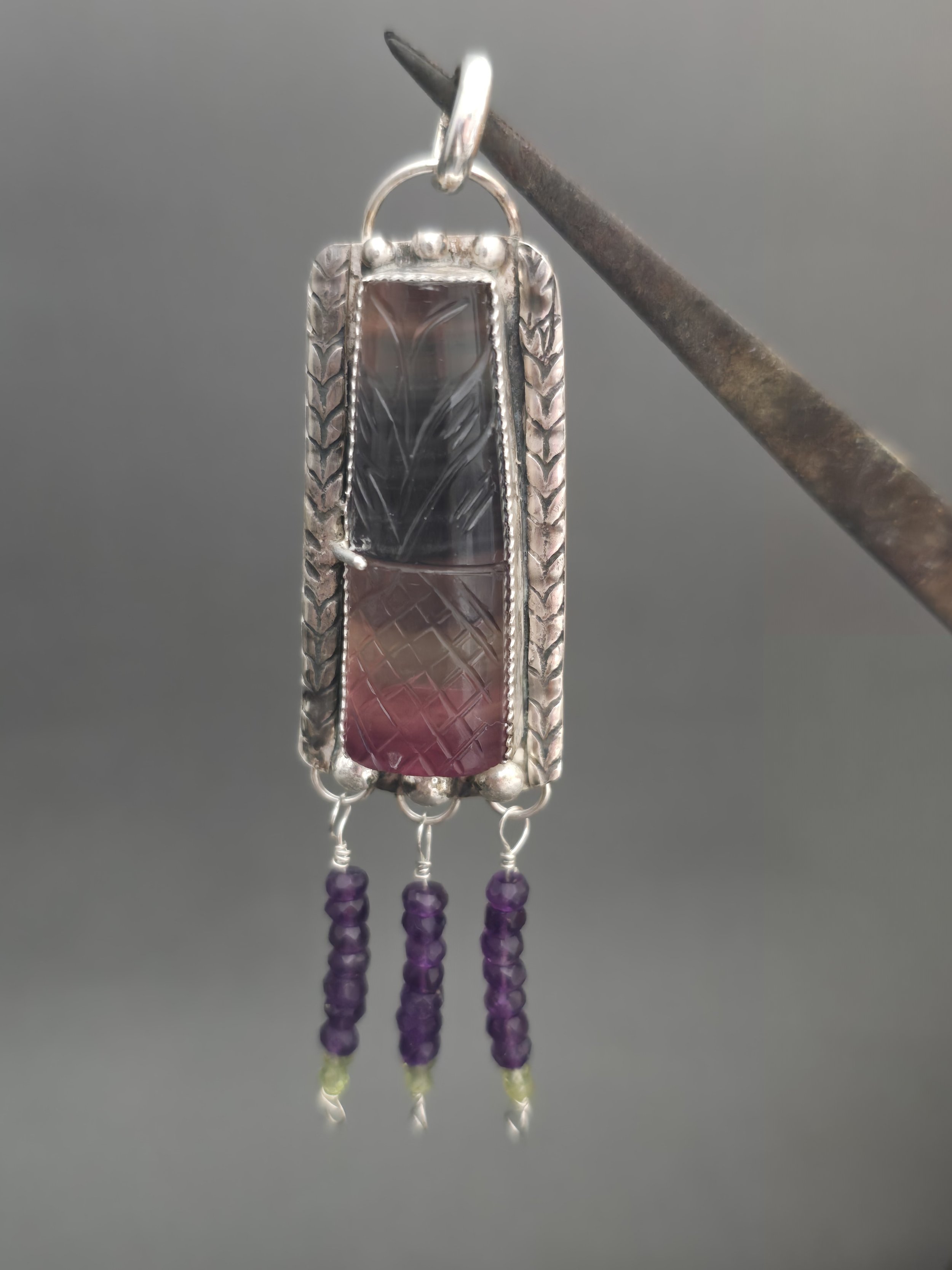 Carved fluorite silver pendant with amethyst beads