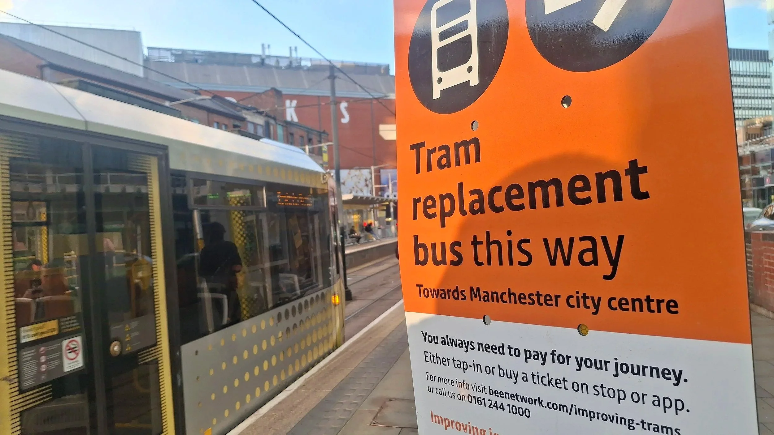 Tram replacement bus sign and a tram leaving Shudehill, 28 September 2026.