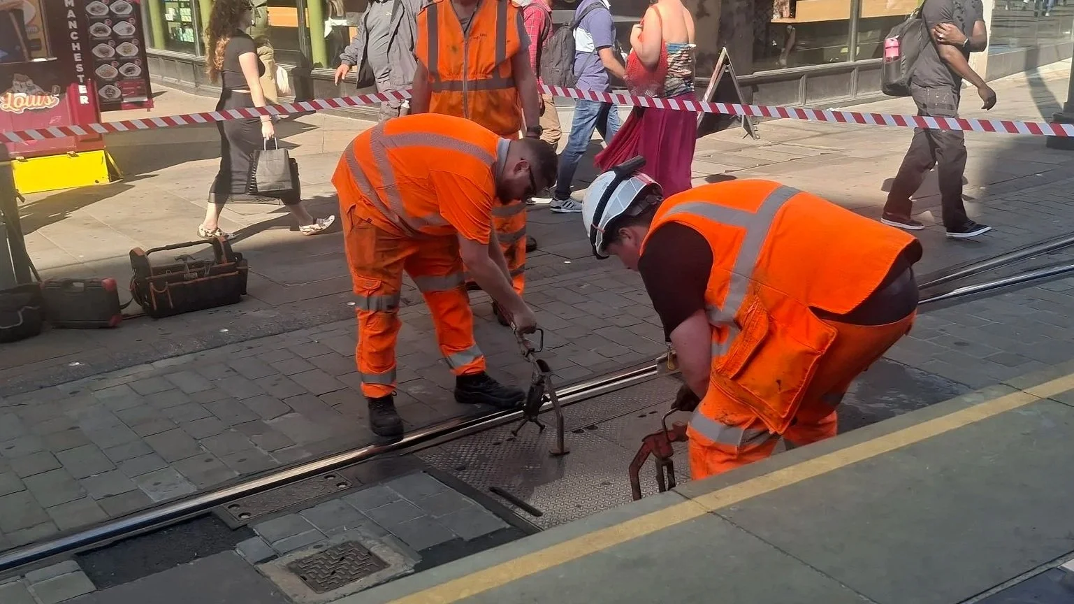 Workers placing points machinery coverings back on at Market Street, 8 July 2026.