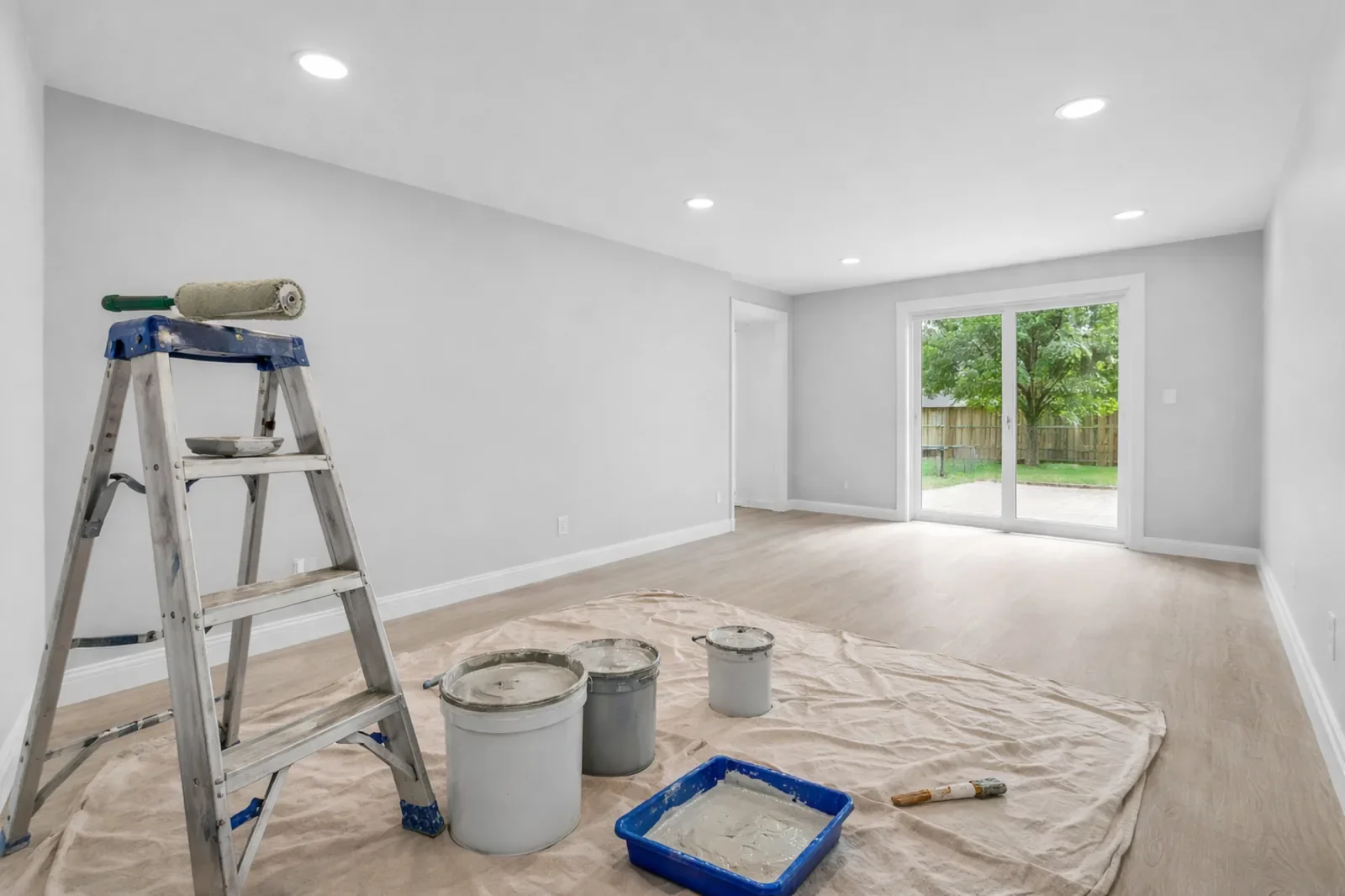 Drywall and painting work in a freshly finished interior with smooth walls, recessed lighting, and clean modern finishes in a Calgary home.