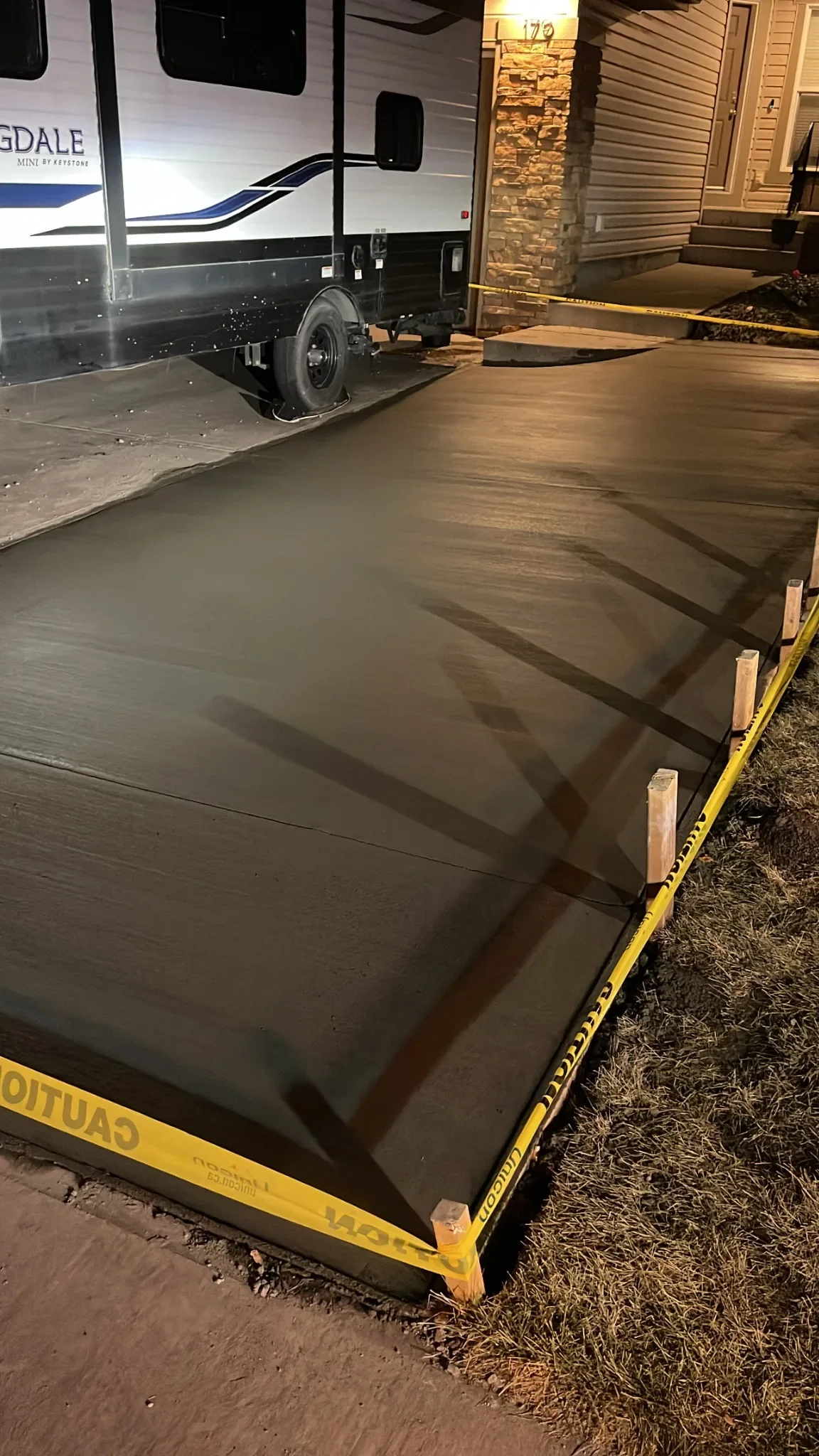 Concrete driveway extension poured to increase parking space and improve access, finished with clean edges and proper curing for long-term durability.