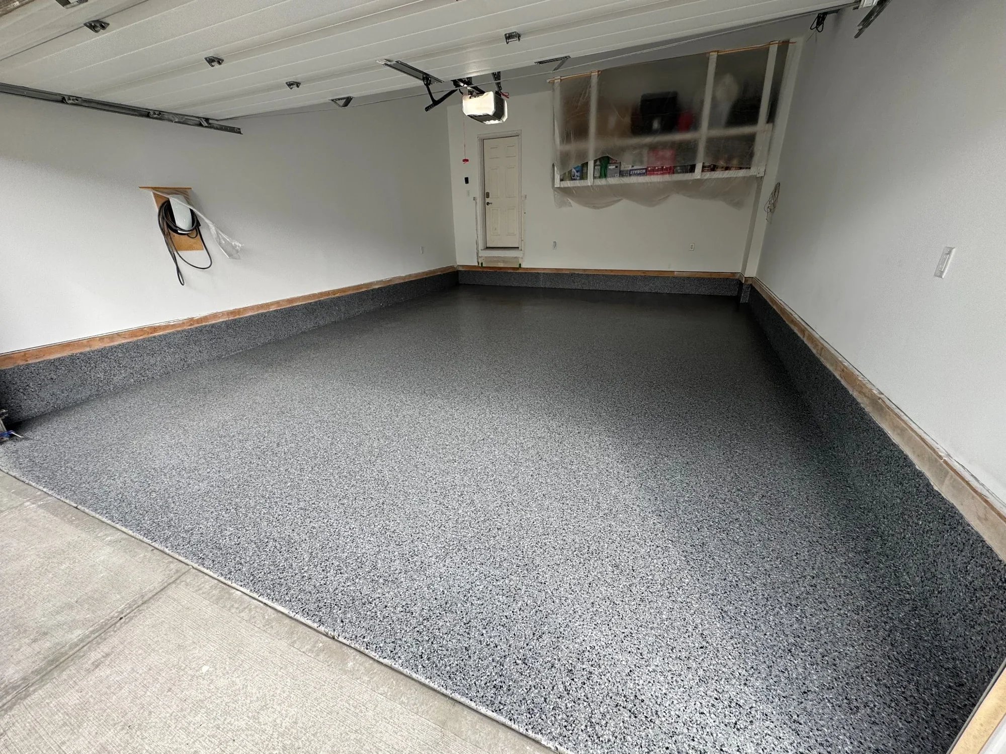 Full garage epoxy floor renovation featuring a durable grey flake system for a clean, modern, and long-lasting finish.