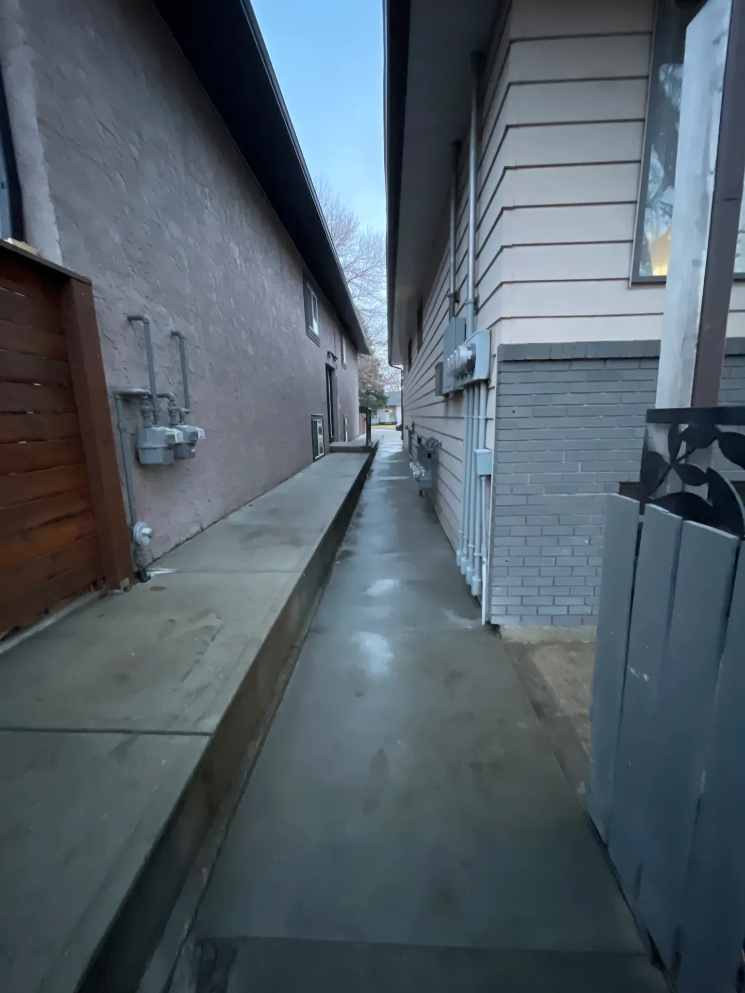 Smooth concrete side-yard walkway providing clean, durable access between neighboring homes. Designed for drainage, longevity, and everyday use, this narrow concrete path is ideal for Calgary residential properties with limited space.
