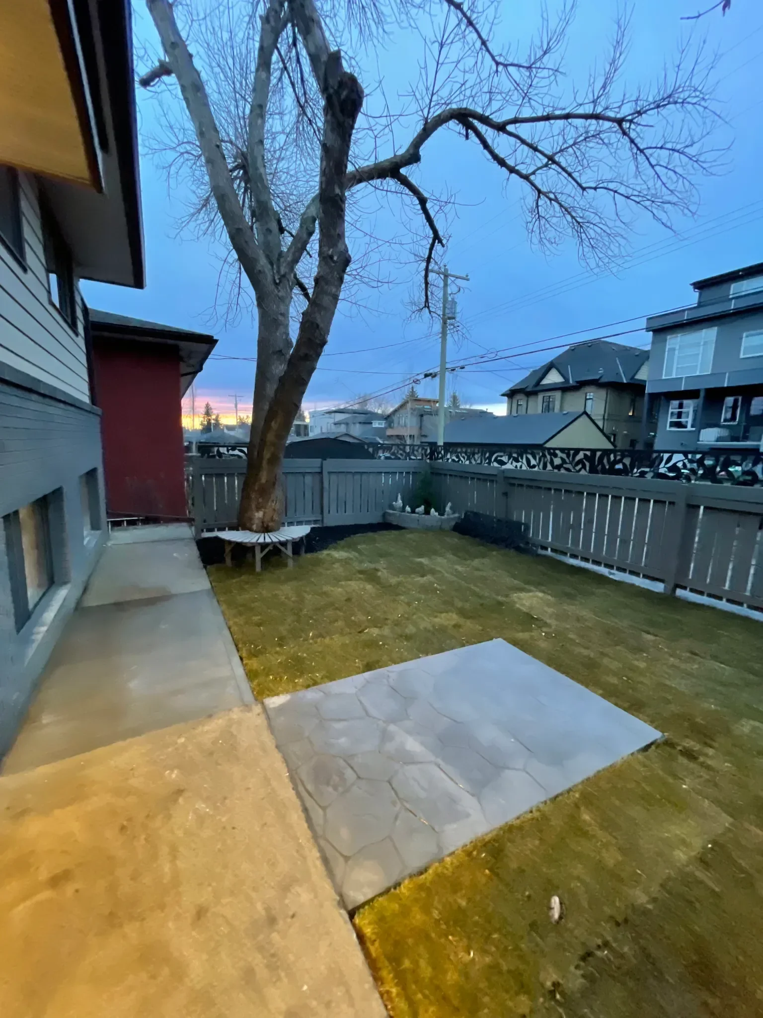 Compact stamped concrete patio with a decorative stone-pattern finish, creating a functional and low-maintenance outdoor space. This patio is ideal for smaller Calgary backyards, offering durability and visual appeal without taking up excessive yard 