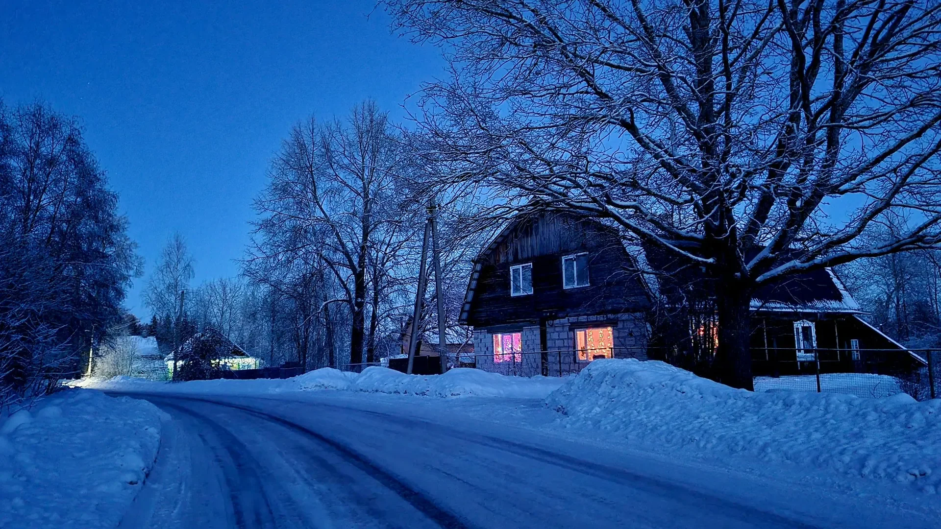 Residential street cleared after professional snow removal service in Calgary at night