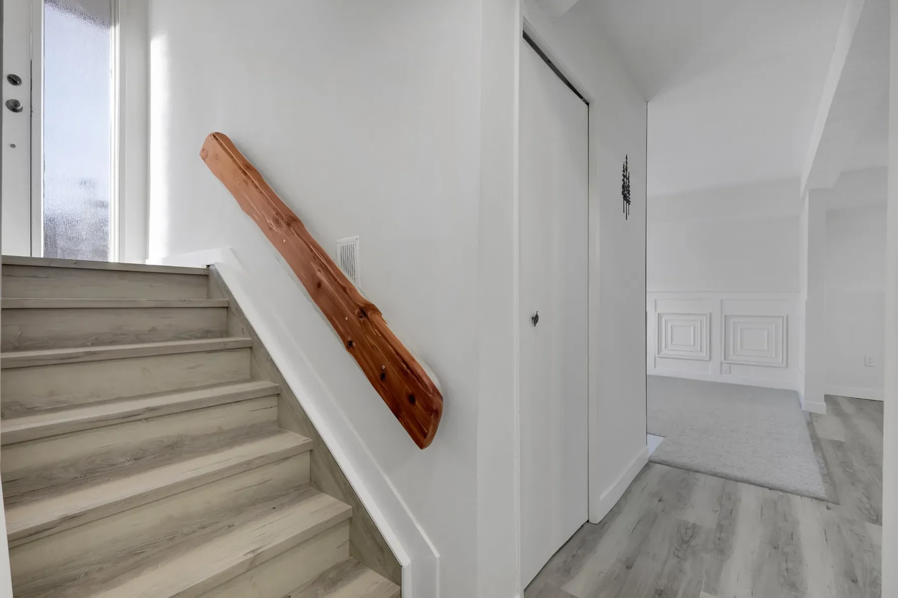 Finished basement renovation in Calgary with modern stairs and floorin