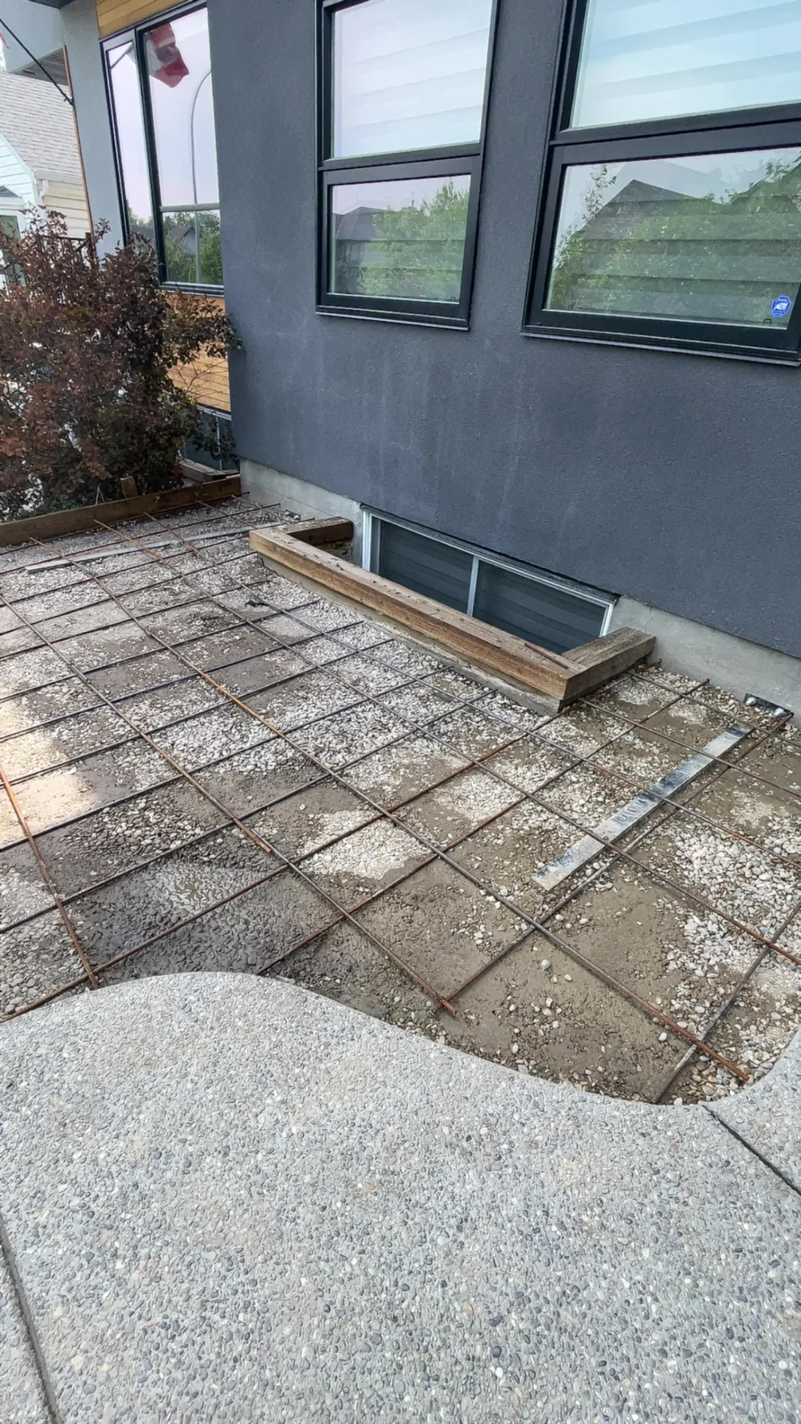 Concrete base preparation showing properly spaced steel rebar reinforcement, ensuring added strength, durability, and long-term performance before the concrete pour.