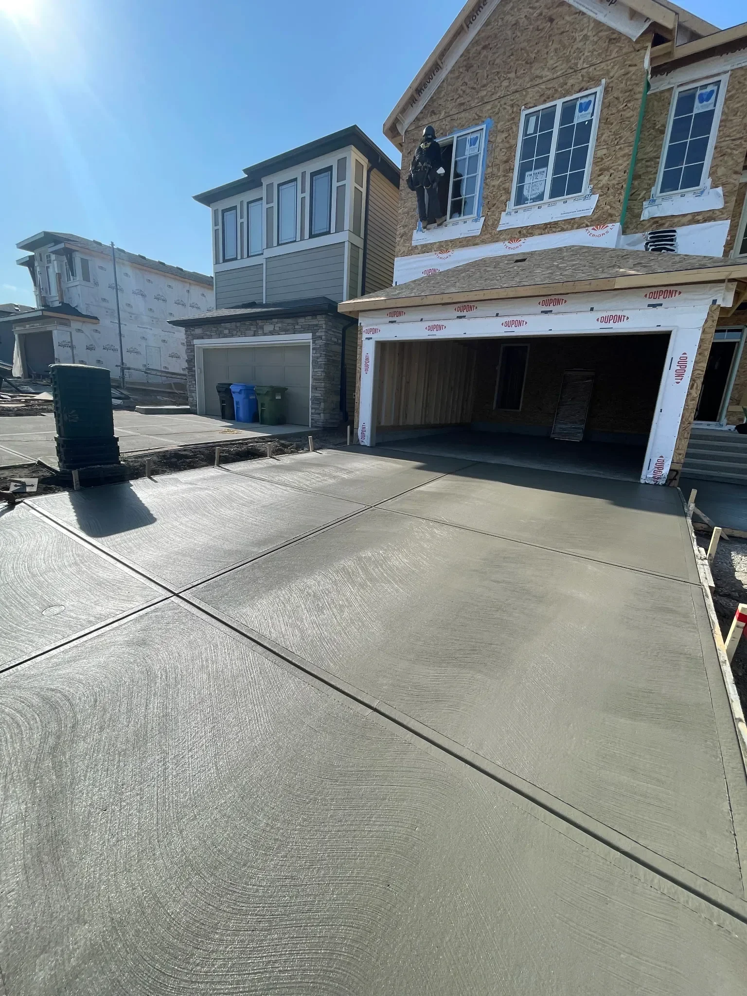 New construction concrete driveway poured with clean expansion joints and a smooth broom finish. Built for durability and long-term performance, this driveway is designed to handle Calgary’s climate while enhancing curb appeal on newly built homes.