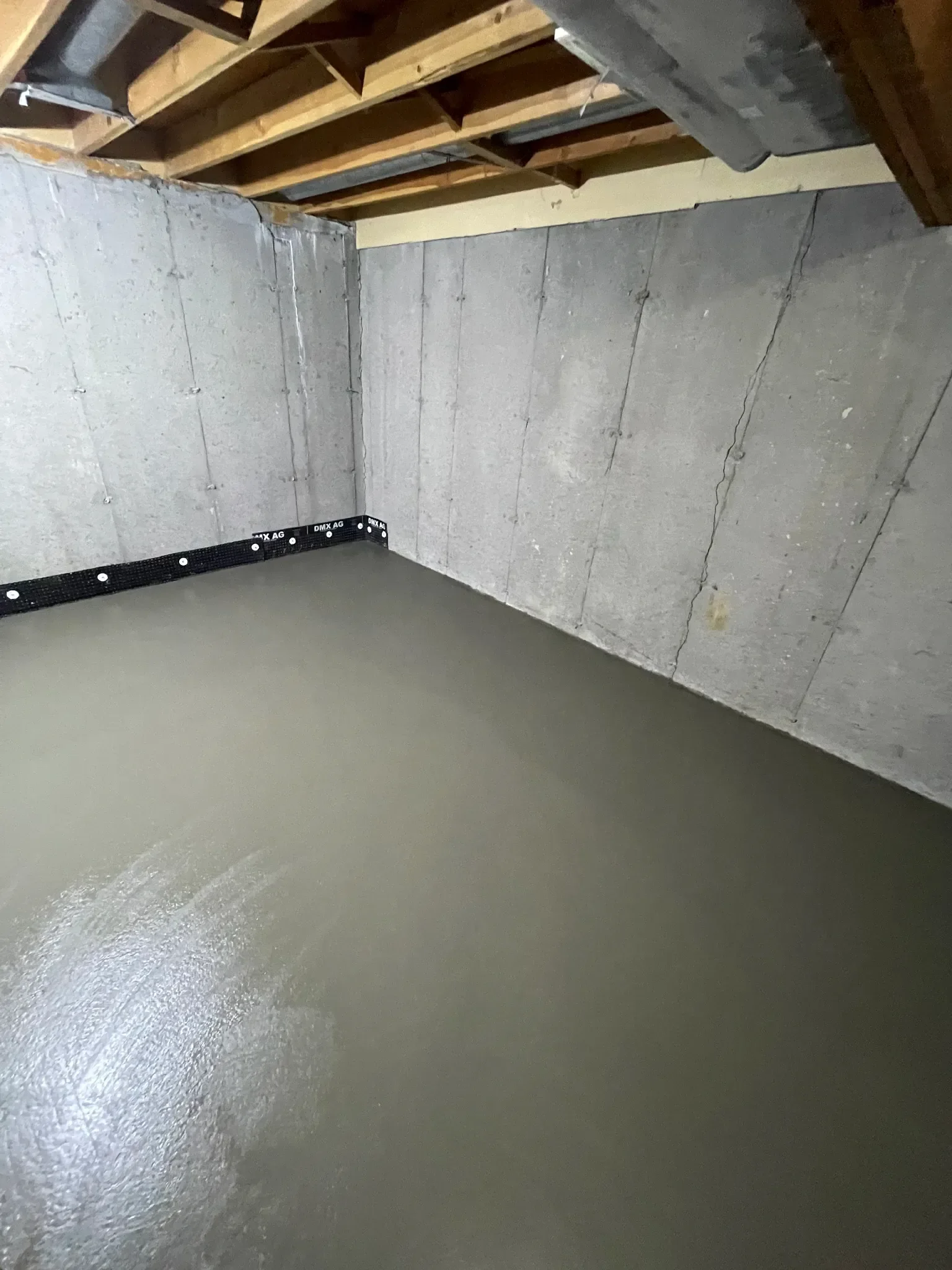 Finished interior concrete slab with a smooth trowel finish, providing a level and durable foundation for basement development. This clean pour is ideal for future flooring installation and long-term residential use in Calgary homes.