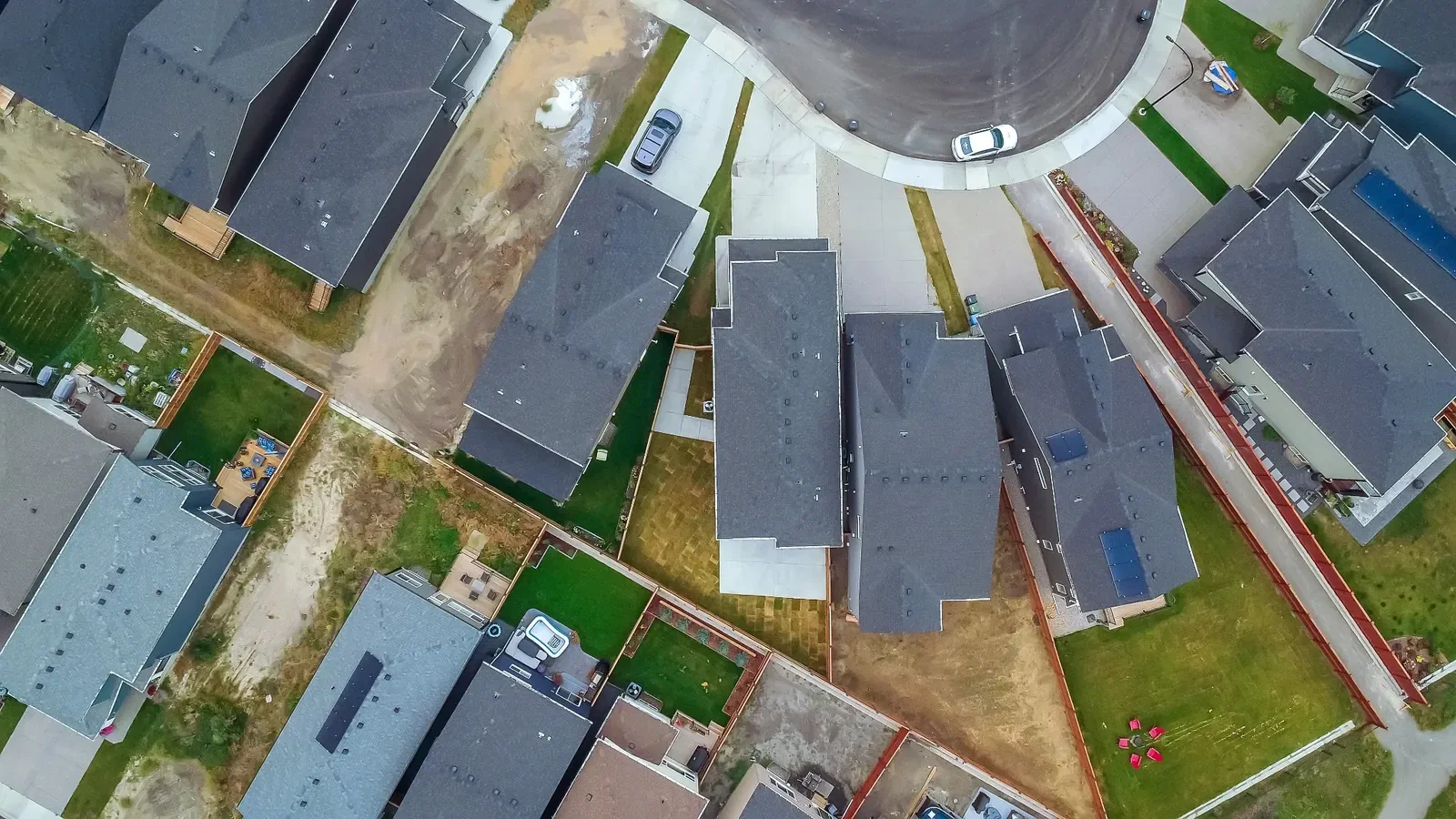 Aerial drone view of residential backyards and landscaping layouts in a Calgary neighbourhood.