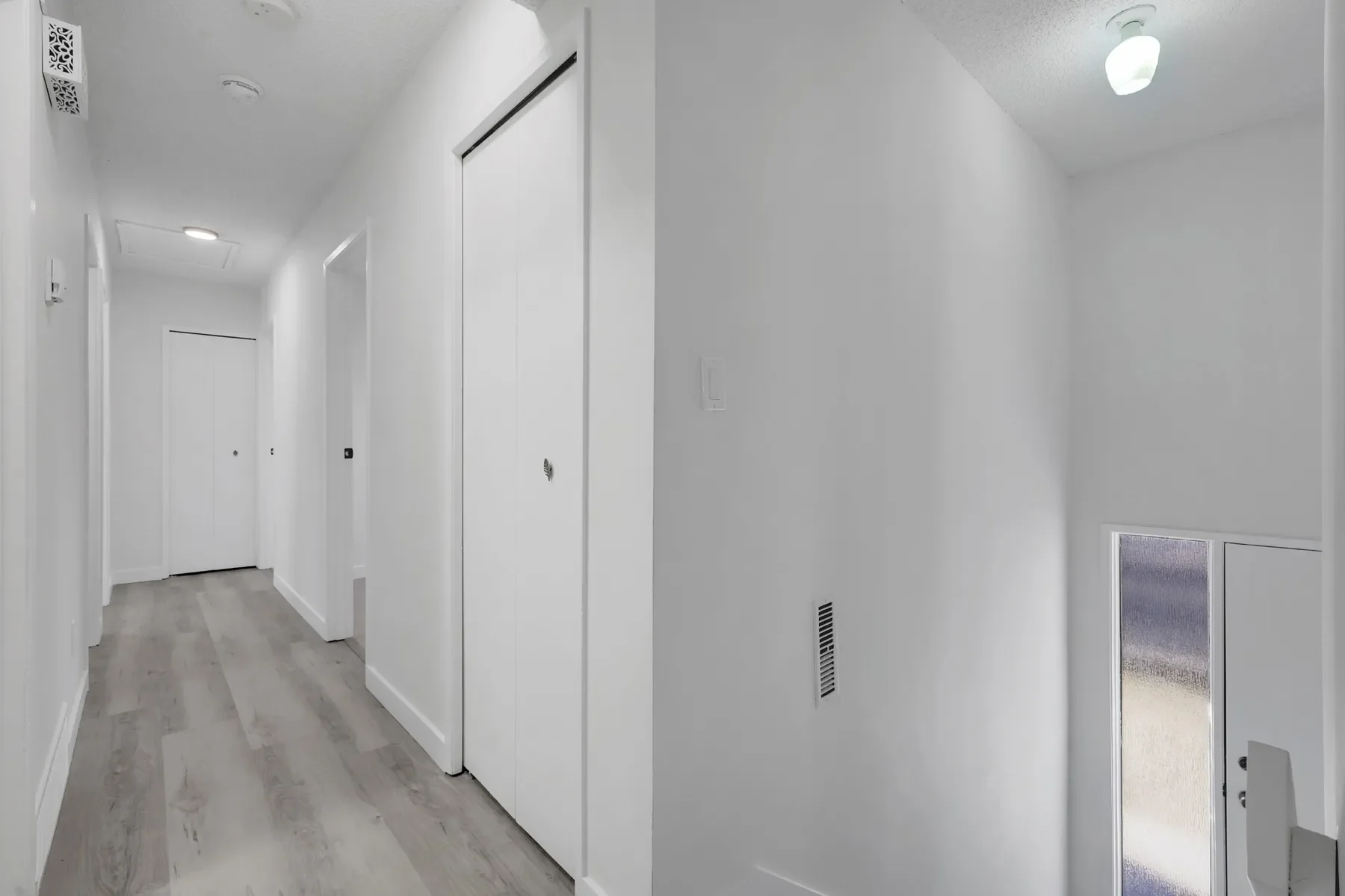 Vinyl plank flooring installation in Calgary hallway with modern finish