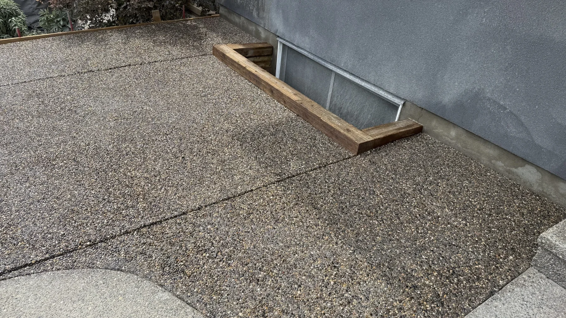 Exposed aggregate concrete patio installation at a residential home in Calgary.