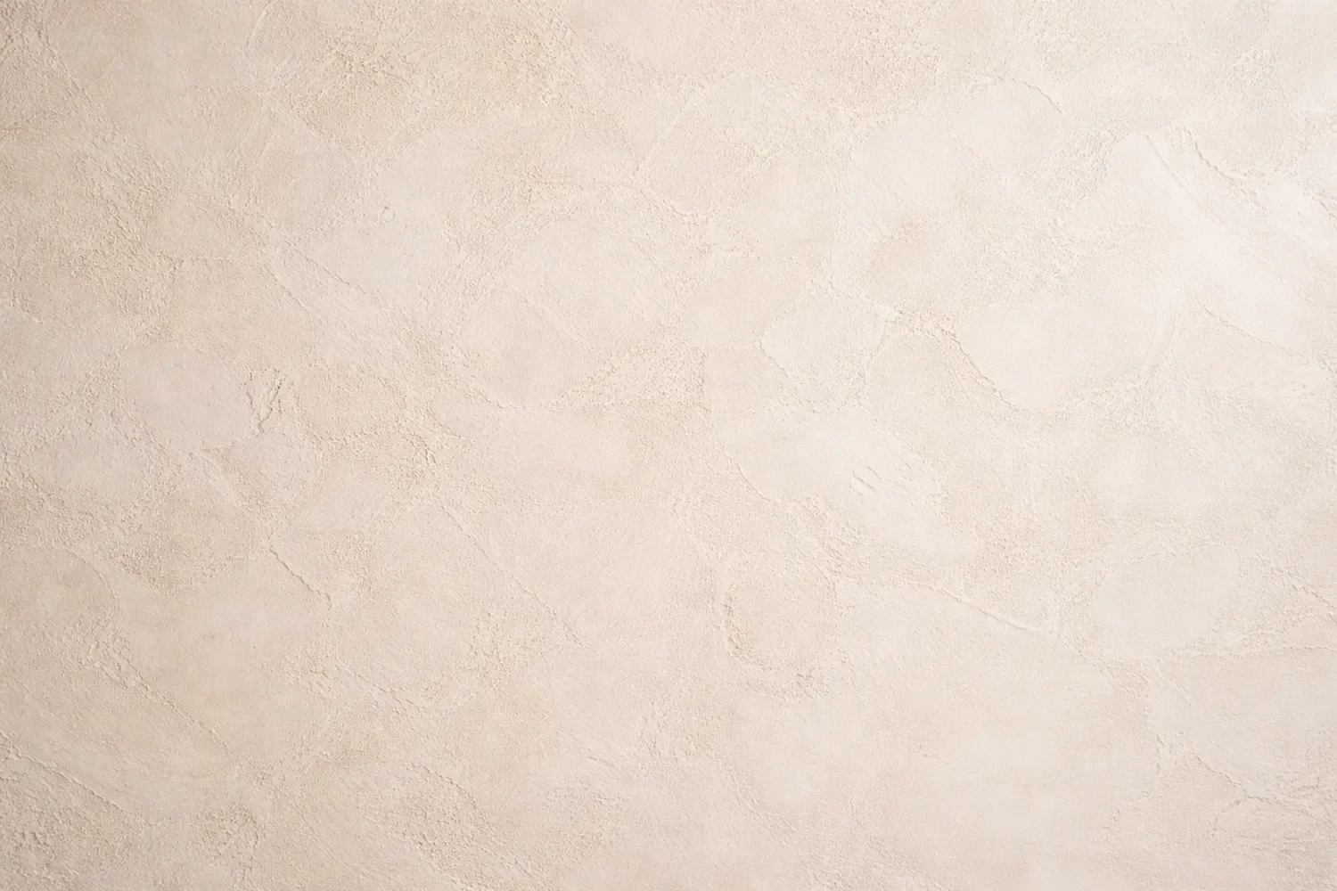 Natural lime plaster wall finish with soft texture and subtle movement, showcasing a traditional Italian plaster surface.