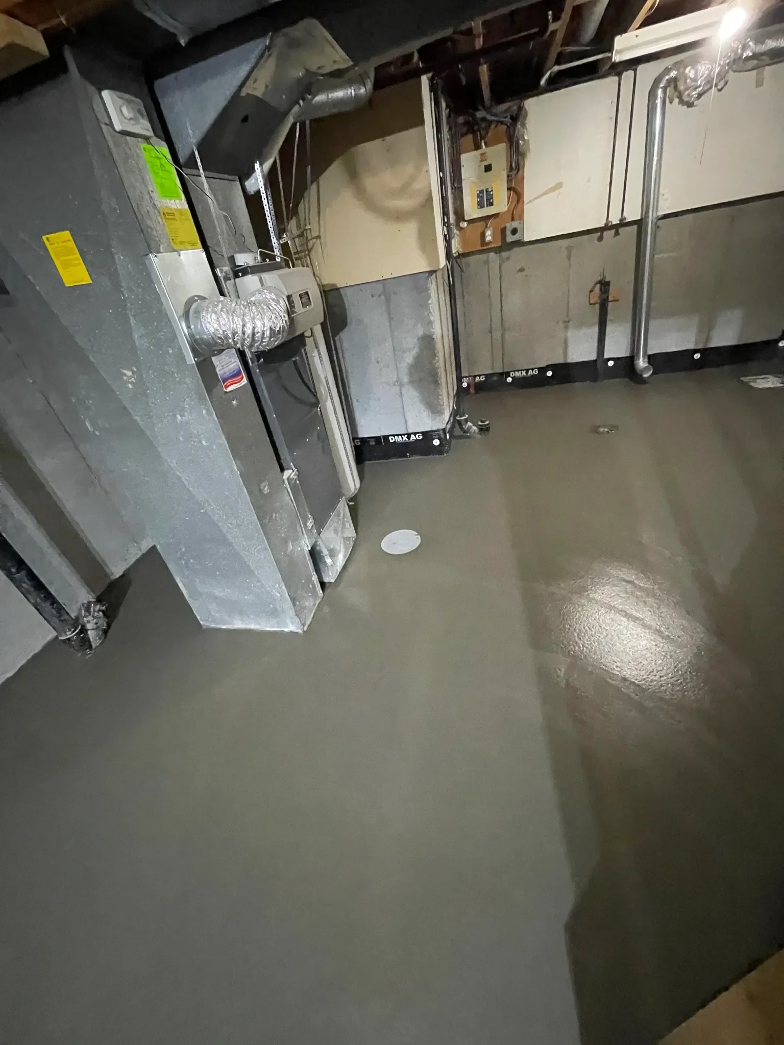Finished concrete slab floor in a basement utility room, poured with a smooth, level finish around mechanical systems. Built for durability and long-term performance, this slab provides a solid foundation for Calgary residential basements and utility