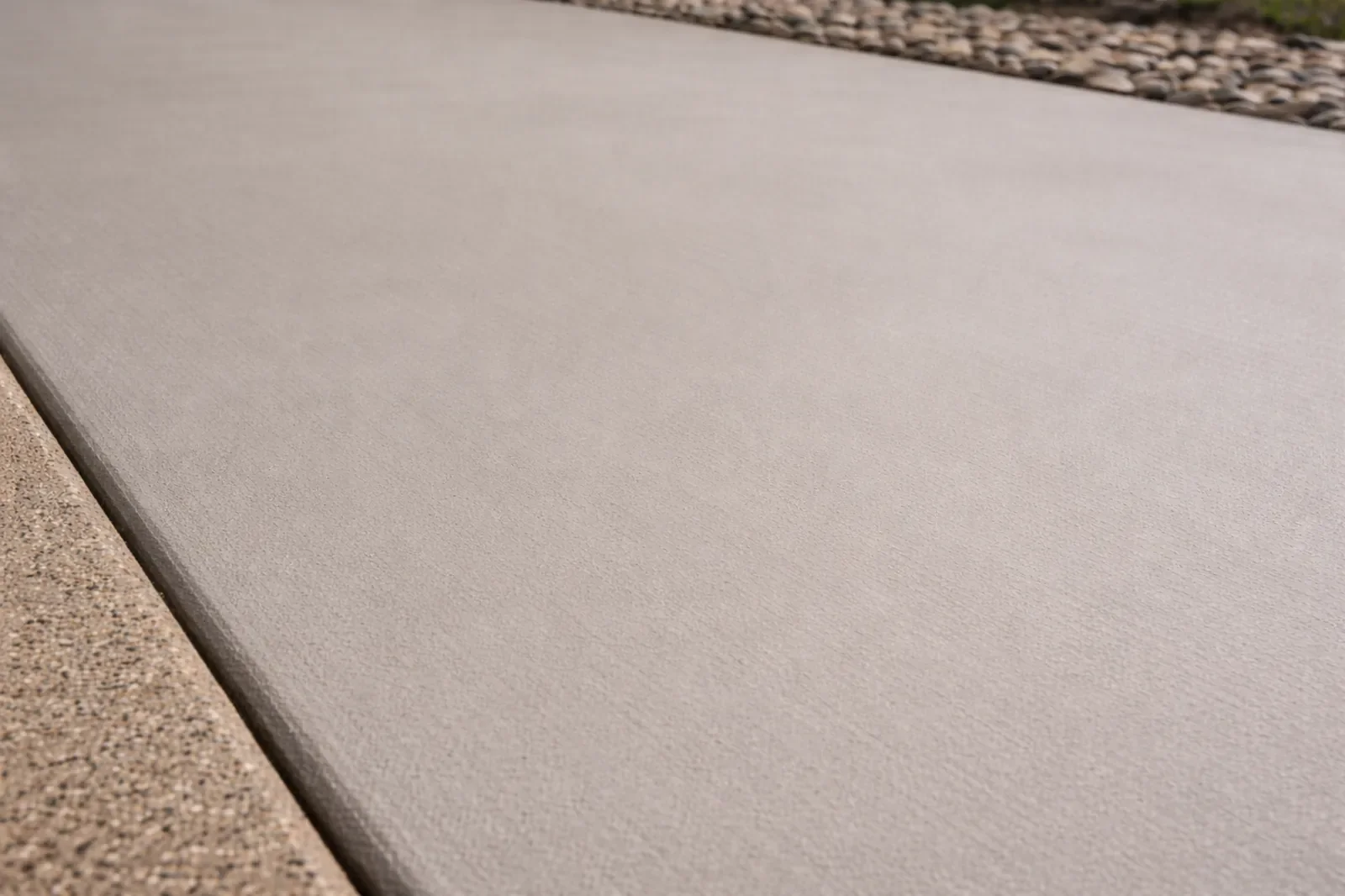 Smooth finish concrete driveway with clean, seamless surface