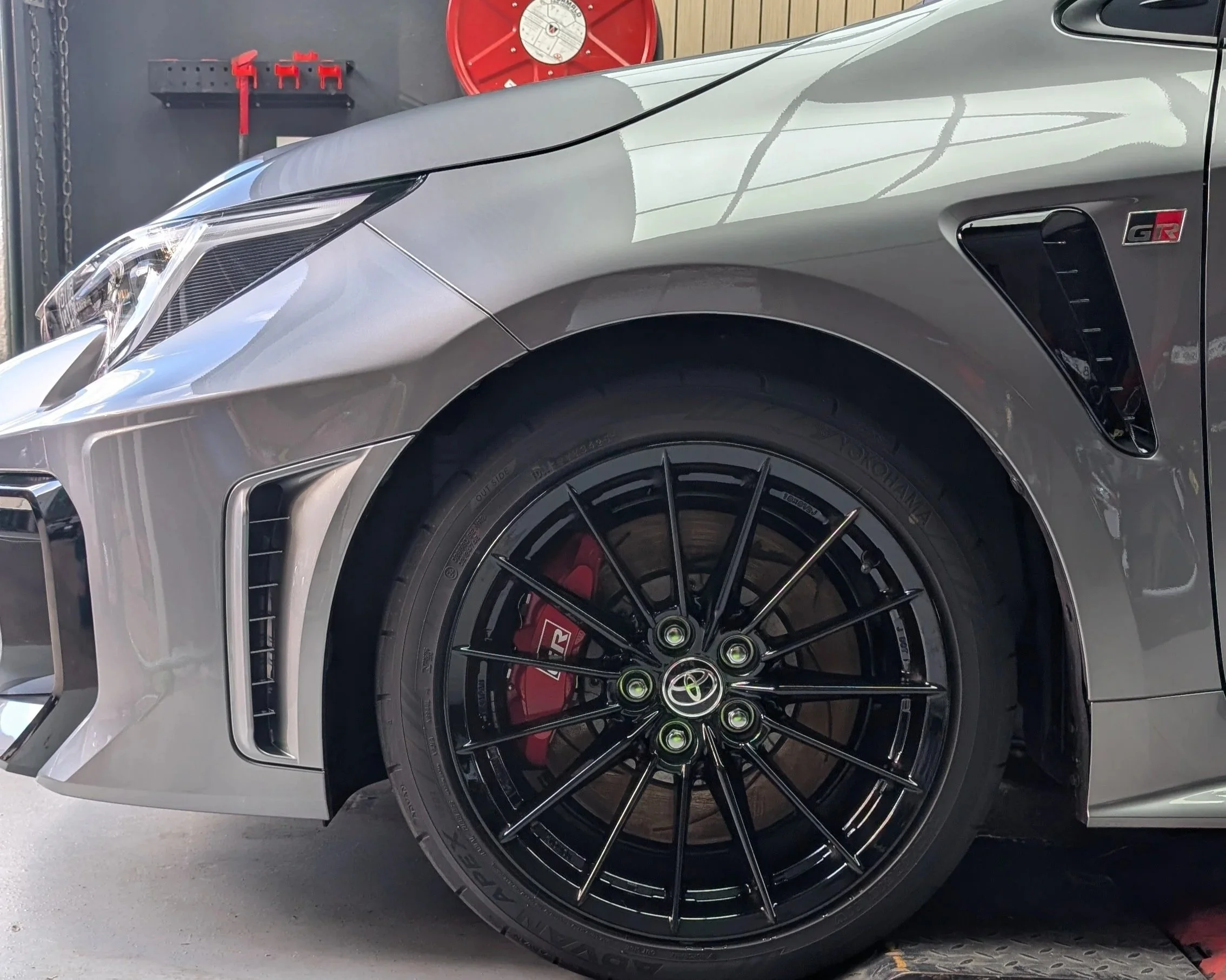 Ceramic coated silver Toyota GR — close-up of headlight, black alloy wheel and brake caliper