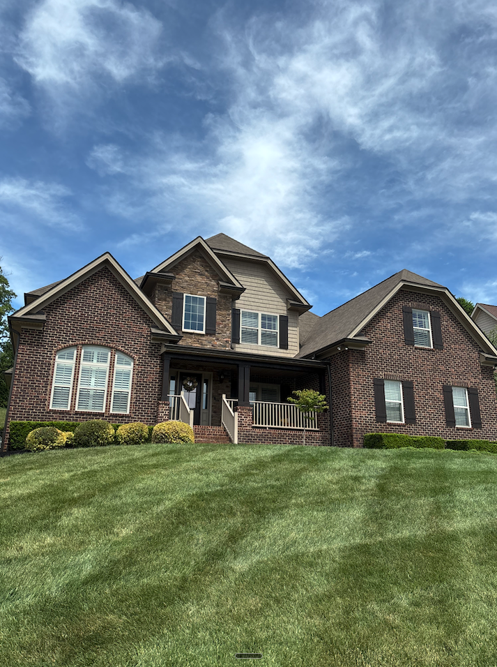 A beautiful house with a pristine mowed yard, done by Knox Exterior Care Co.