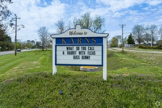 Welcome sign for Karns with a joke about a rabbit with fleas, bugs, and a bunny.