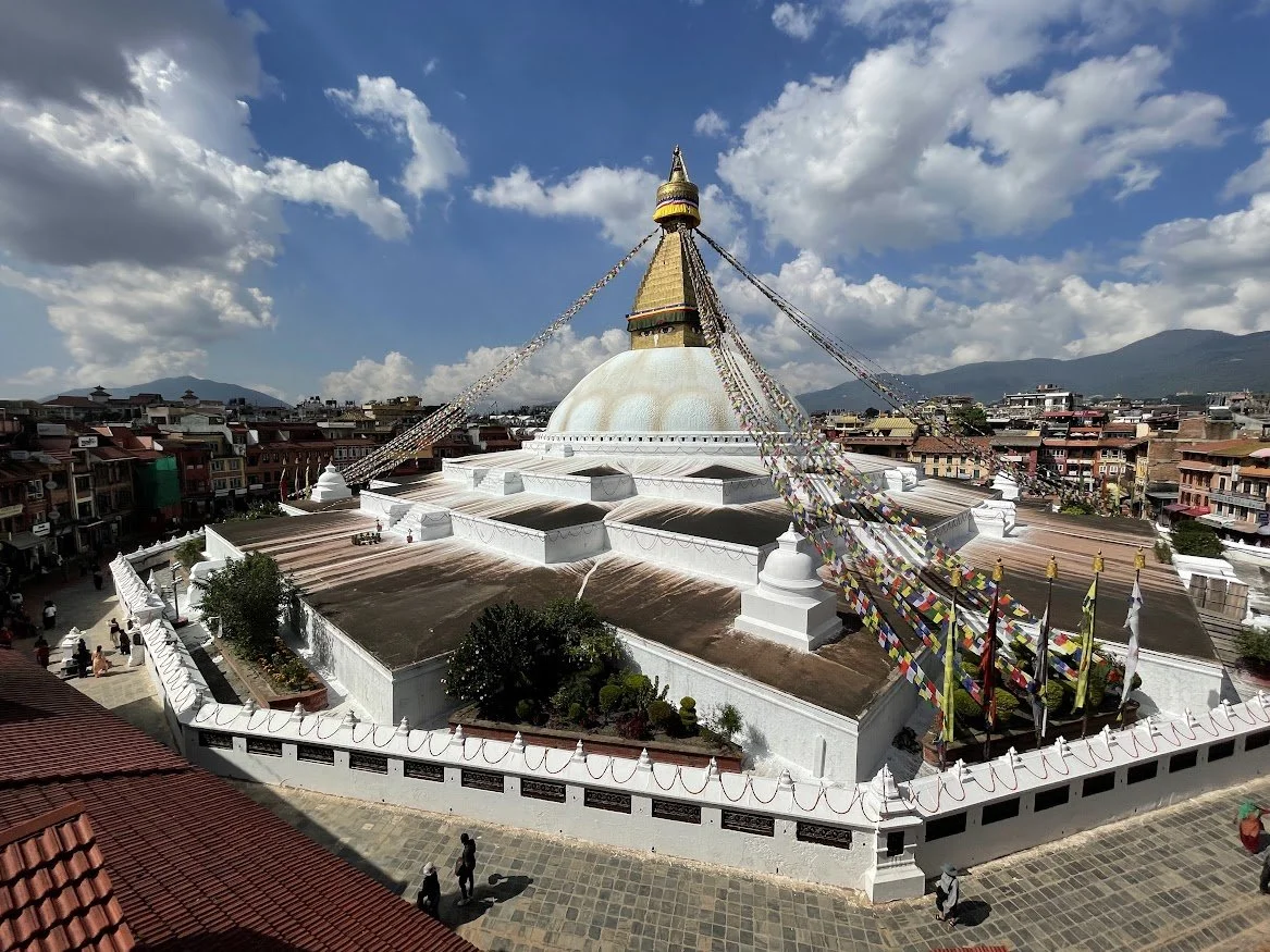 stupa in nepal white prayerflags bleu sky