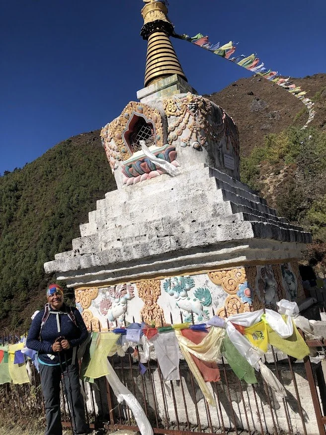 woman in front of stupa in himalayan mountains