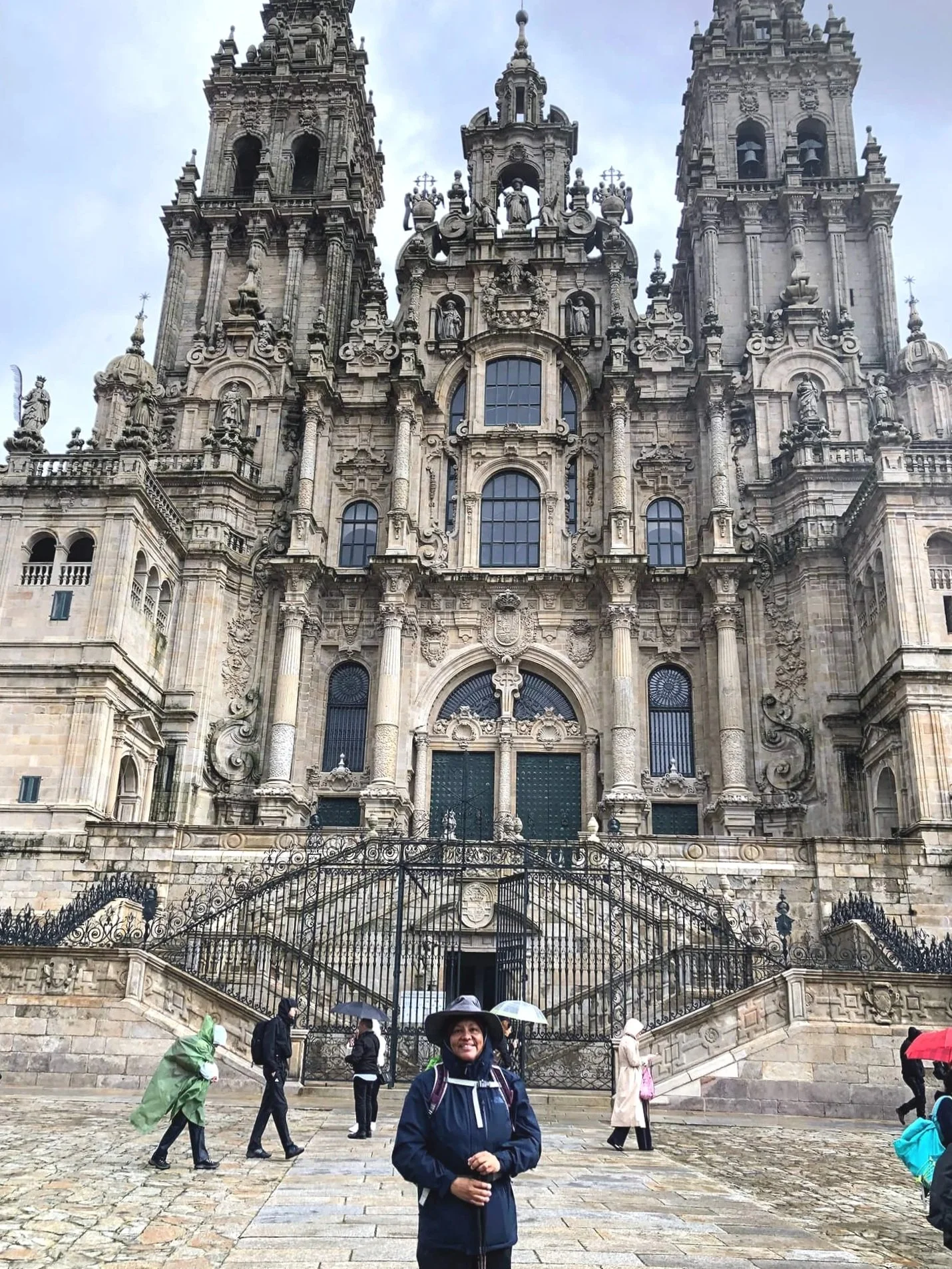 Cathedral of Camino de Santiago with women hiker in front