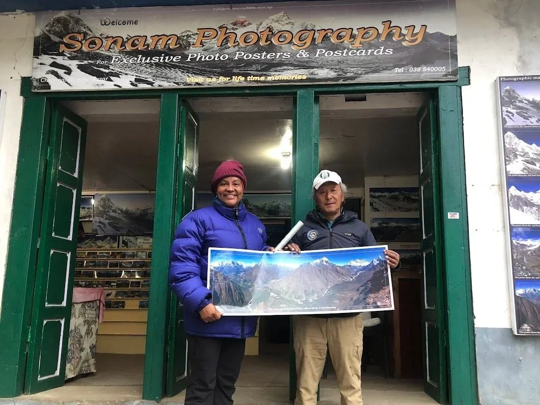 woman in front of sonam photography store with owner