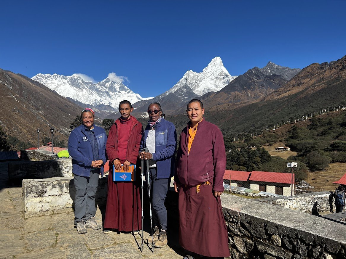 woman hikers with months on everest base camp trail monastary temple