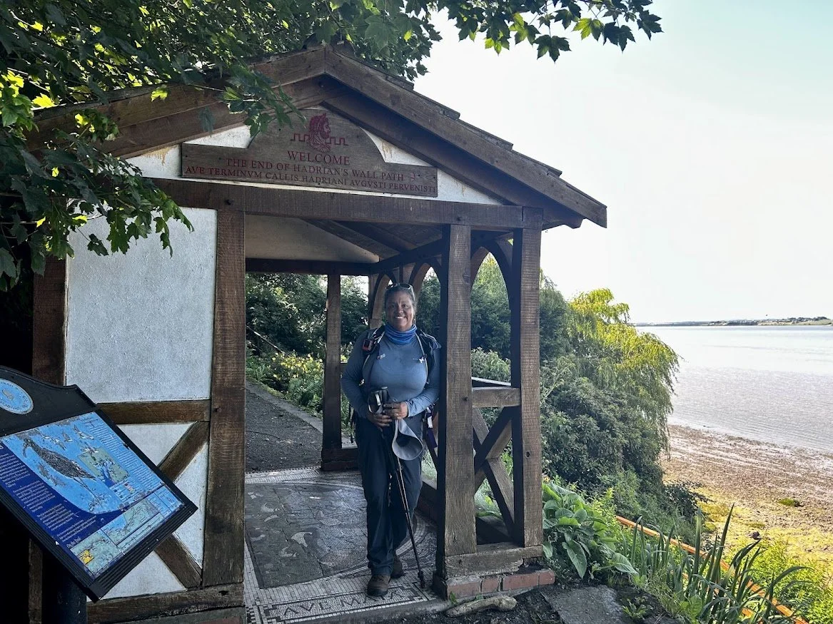 seaside cabana hut with woman hiker green trees and grass