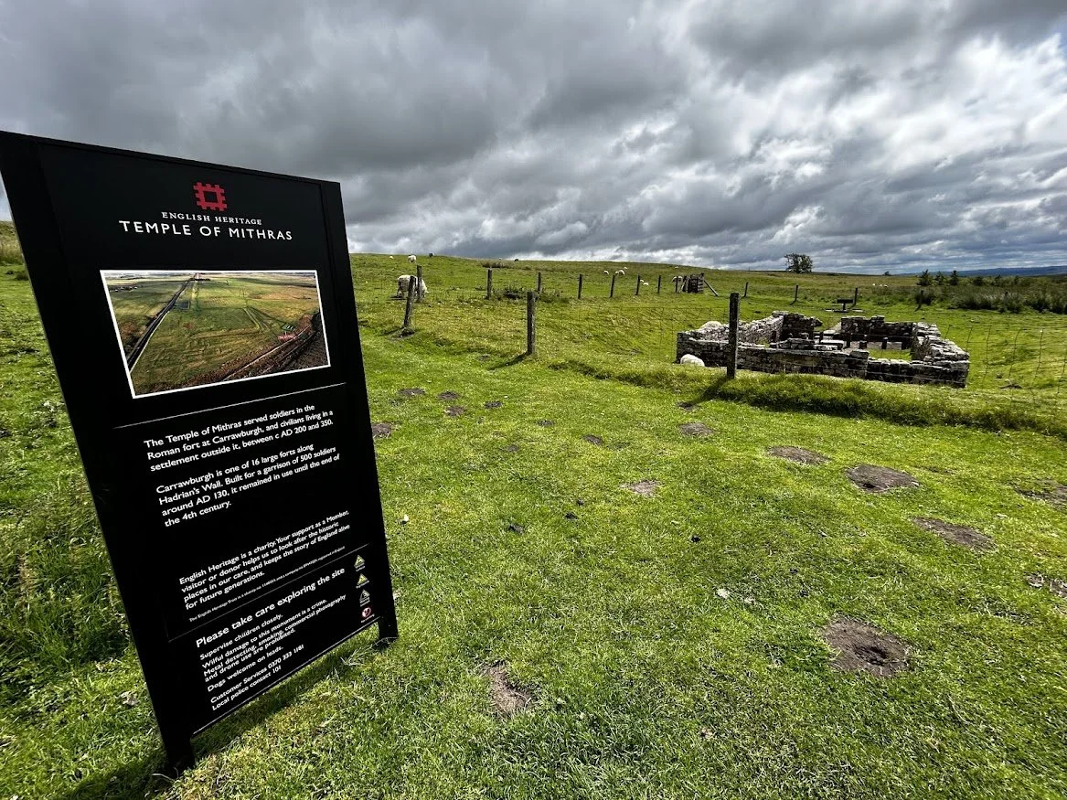 countryside field with sign post of roman heritage temple in england green space