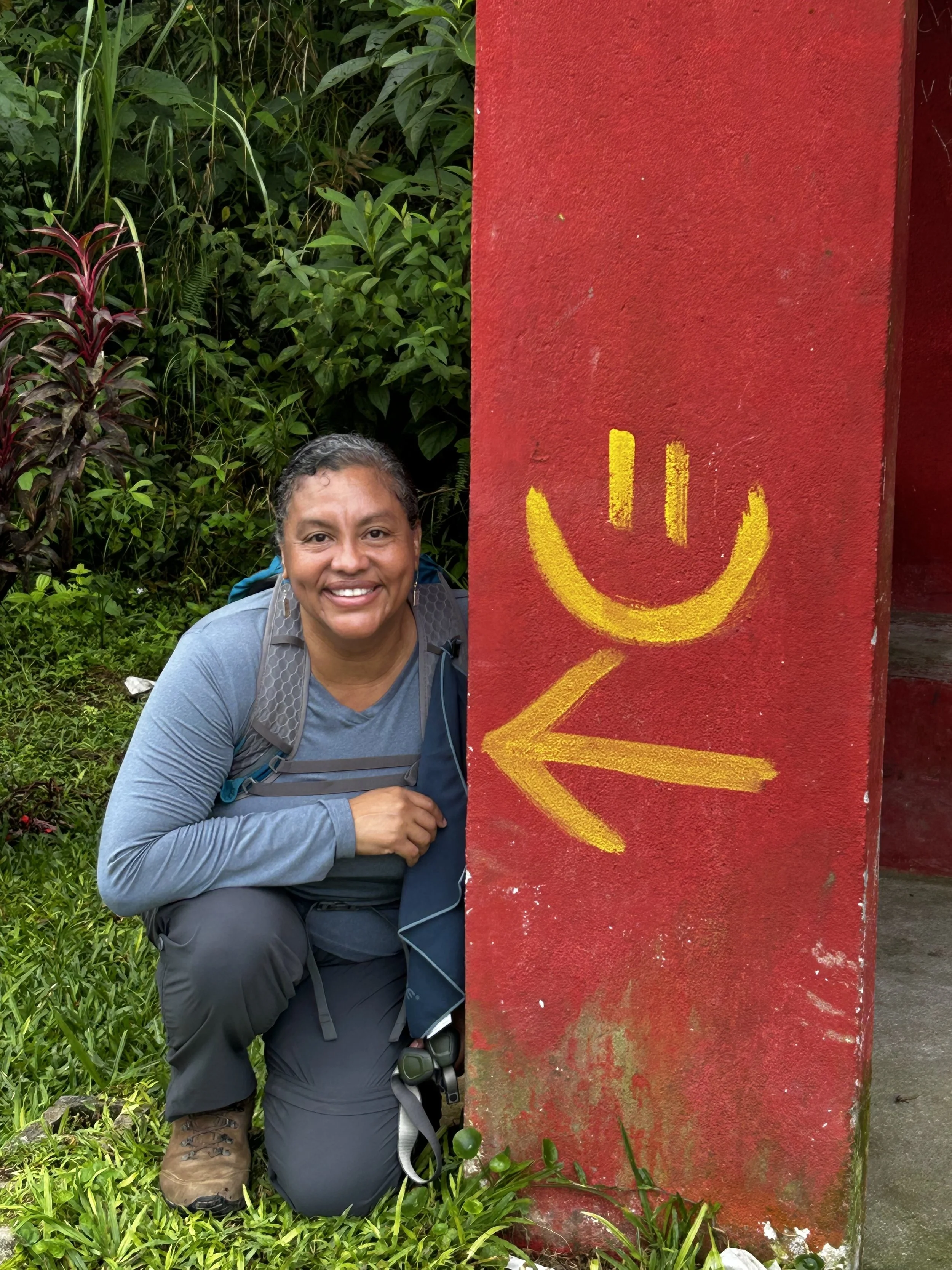 woman hiker smiling next to a smiley face